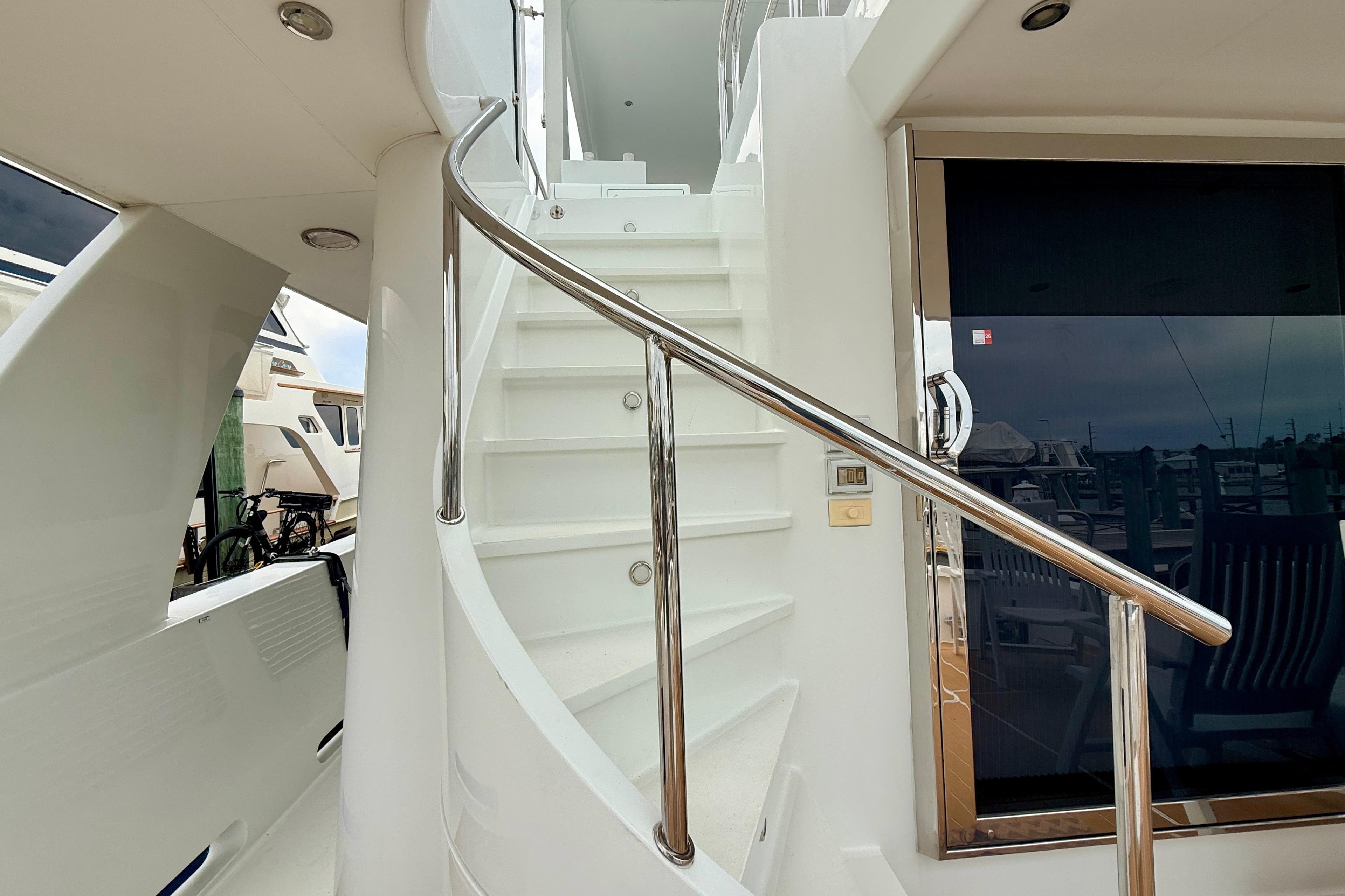 Staircase on 2002 Cheoy Lee 72 Raised Pilot House Motor Yacht, featuring sleek design and polished railing.