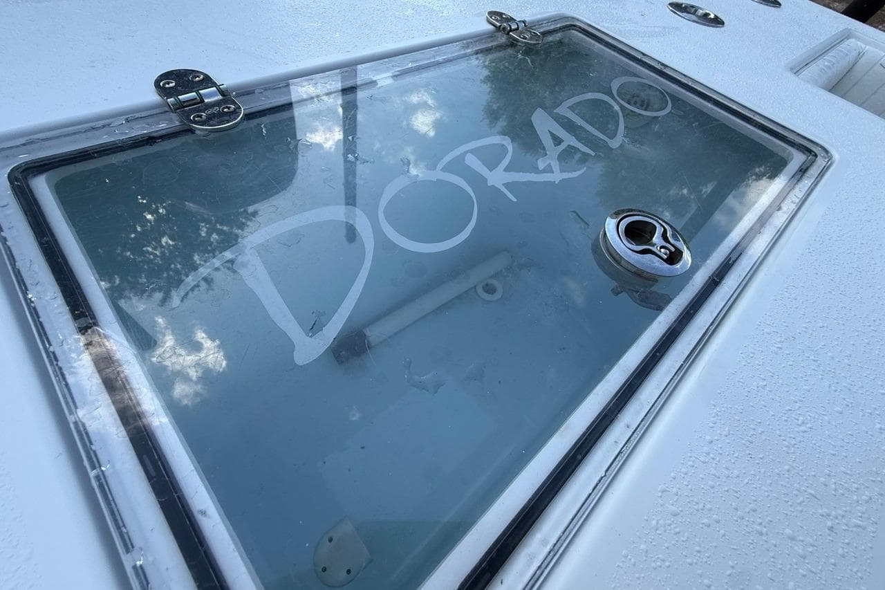 Close-up of a 2017 Dorado 25 SE boat hatch with visible logo.