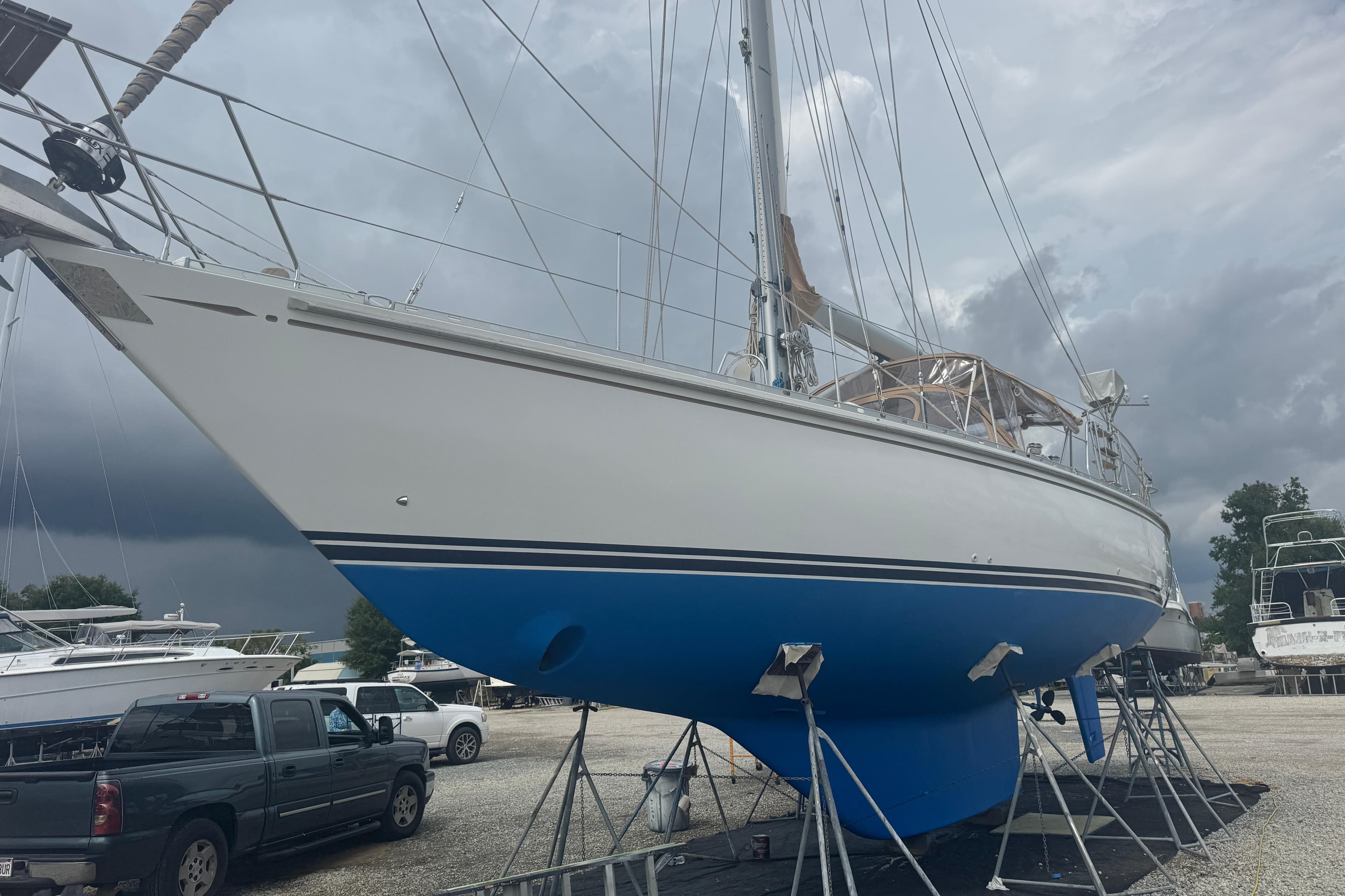 Sailboat Hylas 49CC 2012 on stands, cloudy sky background.