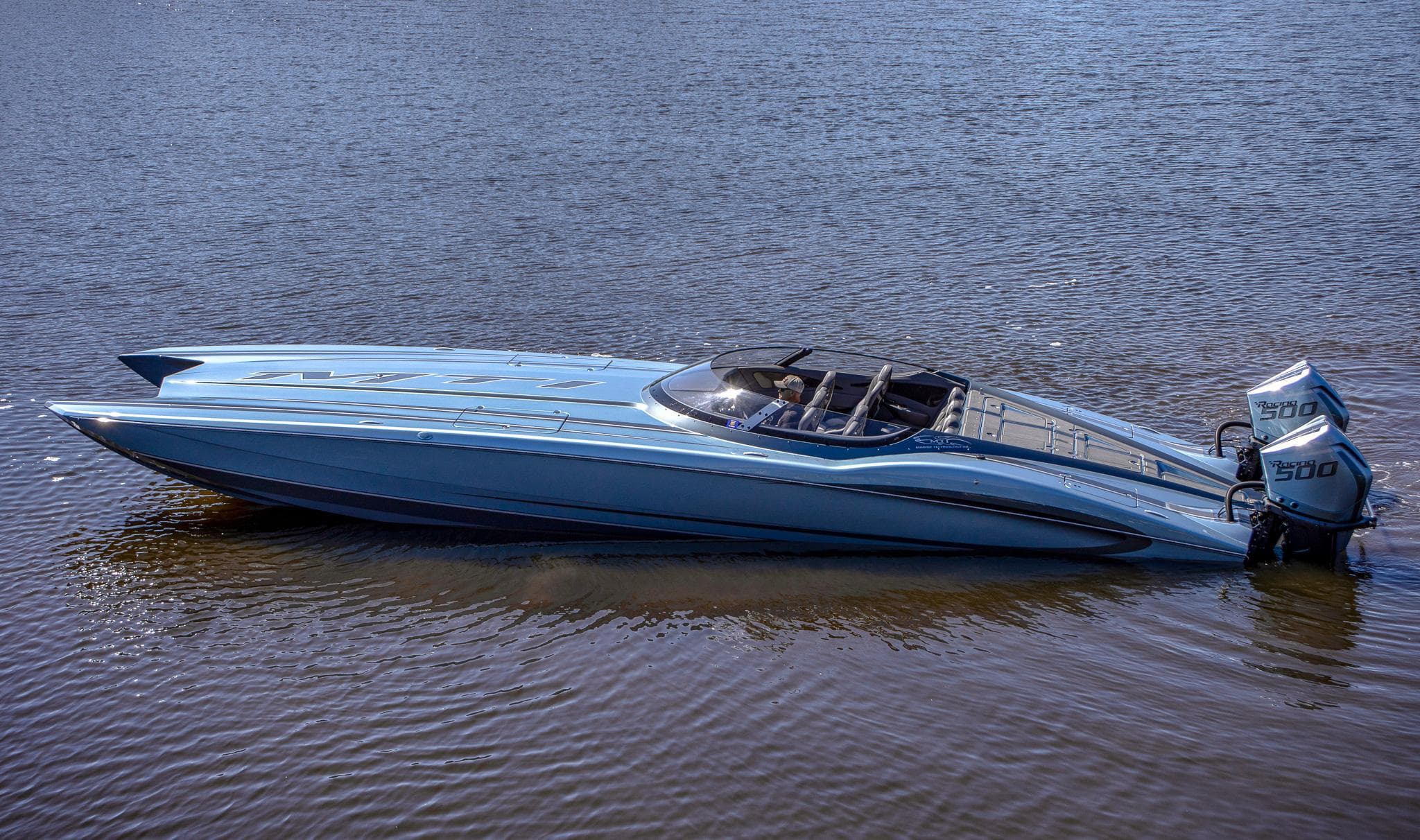 2024 MTI 390X powerboat on water, sleek design, light blue color, dual engines.