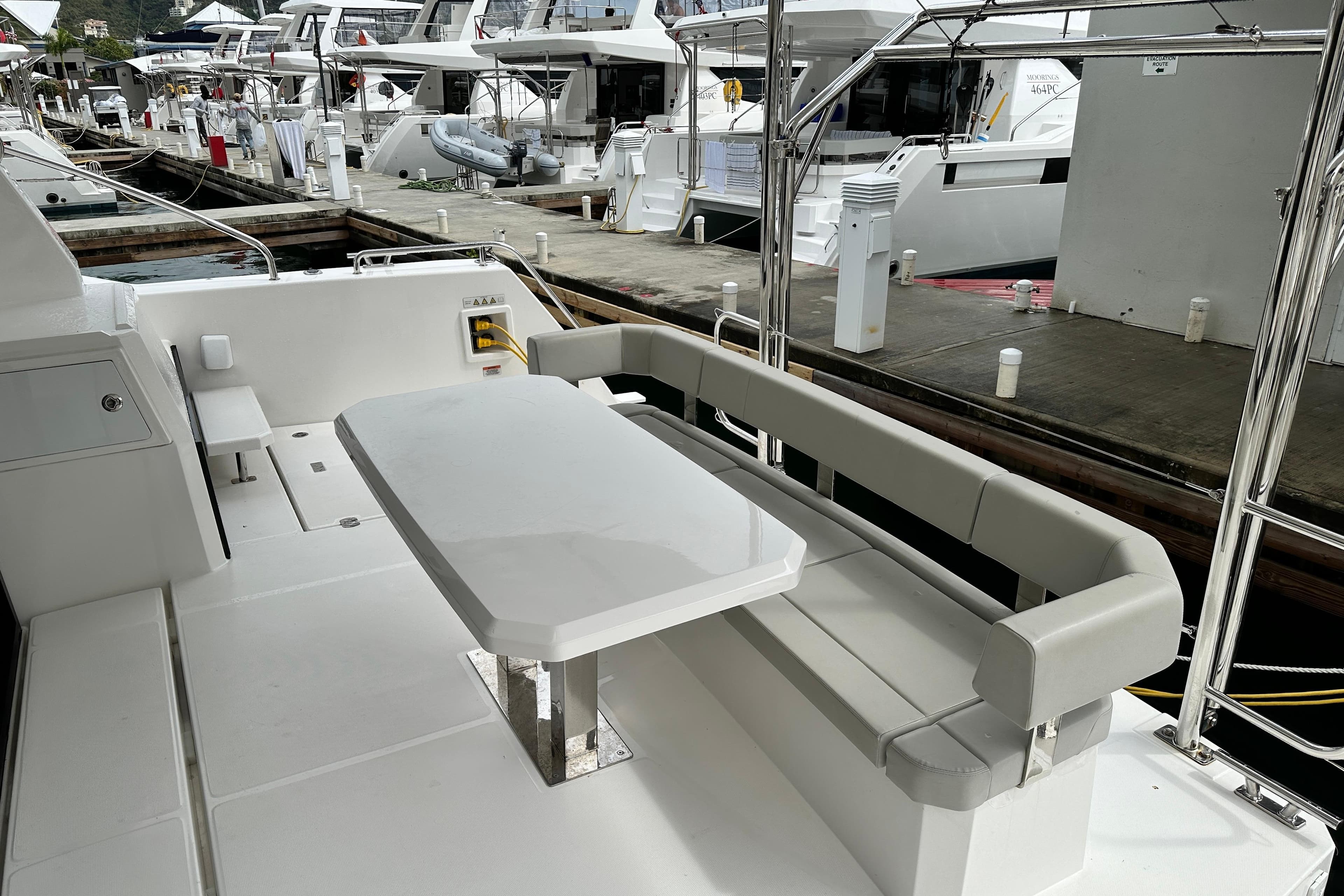 Leopard 40 Powercat 2025 yacht deck with seating and table at marina.
