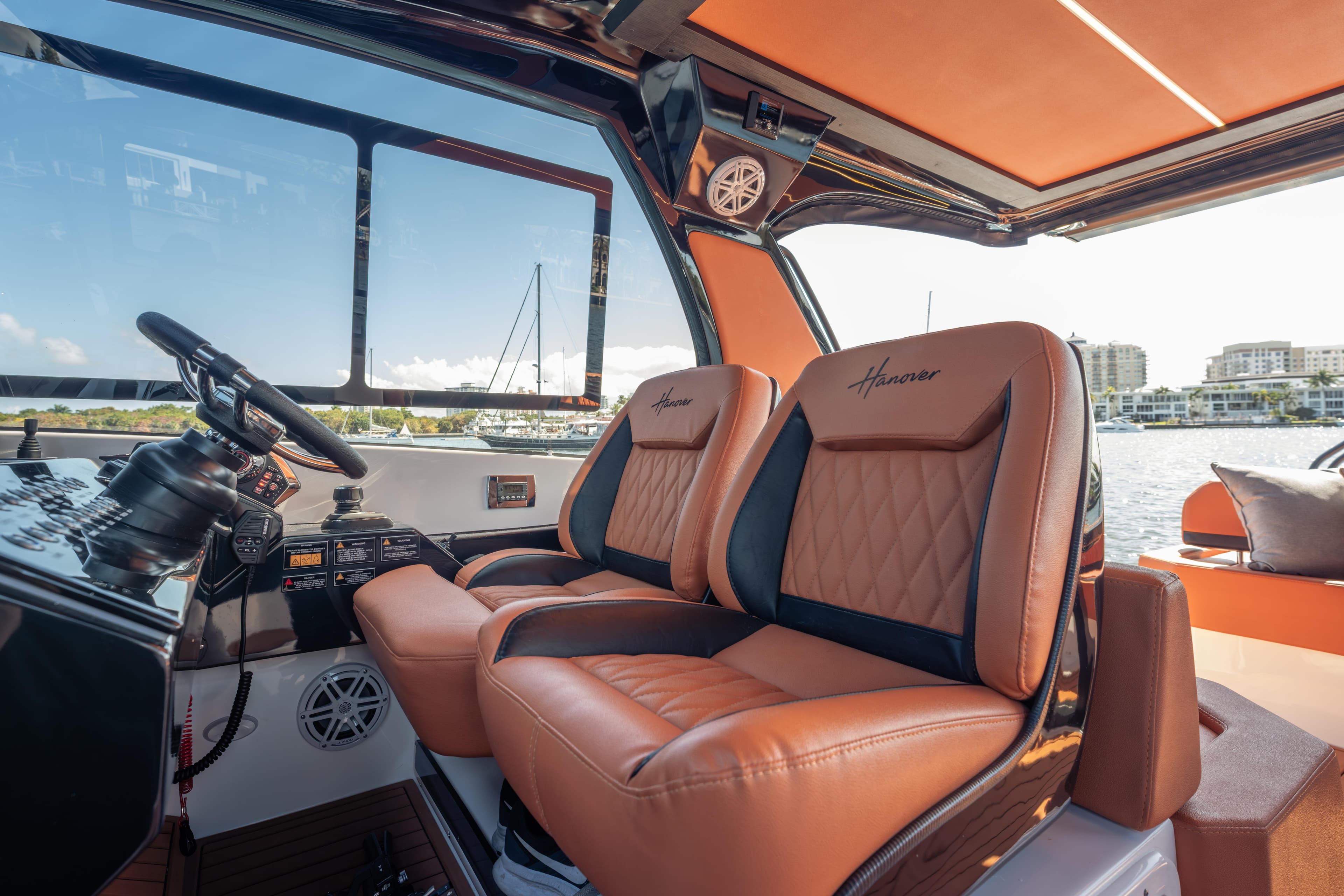 Luxurious interior of 2026 Hanover 387 boat with leather seats and modern controls.