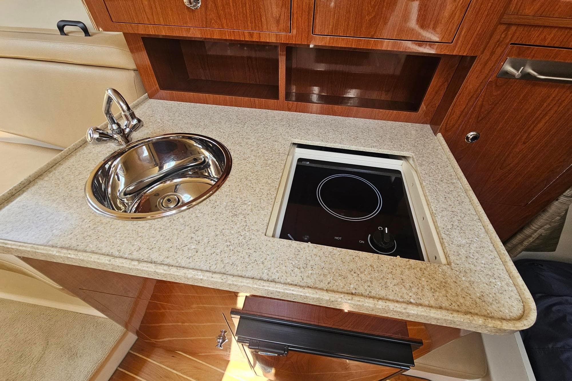 2009 Regal 2860 Window Express boat interior with sink and stove in kitchenette.