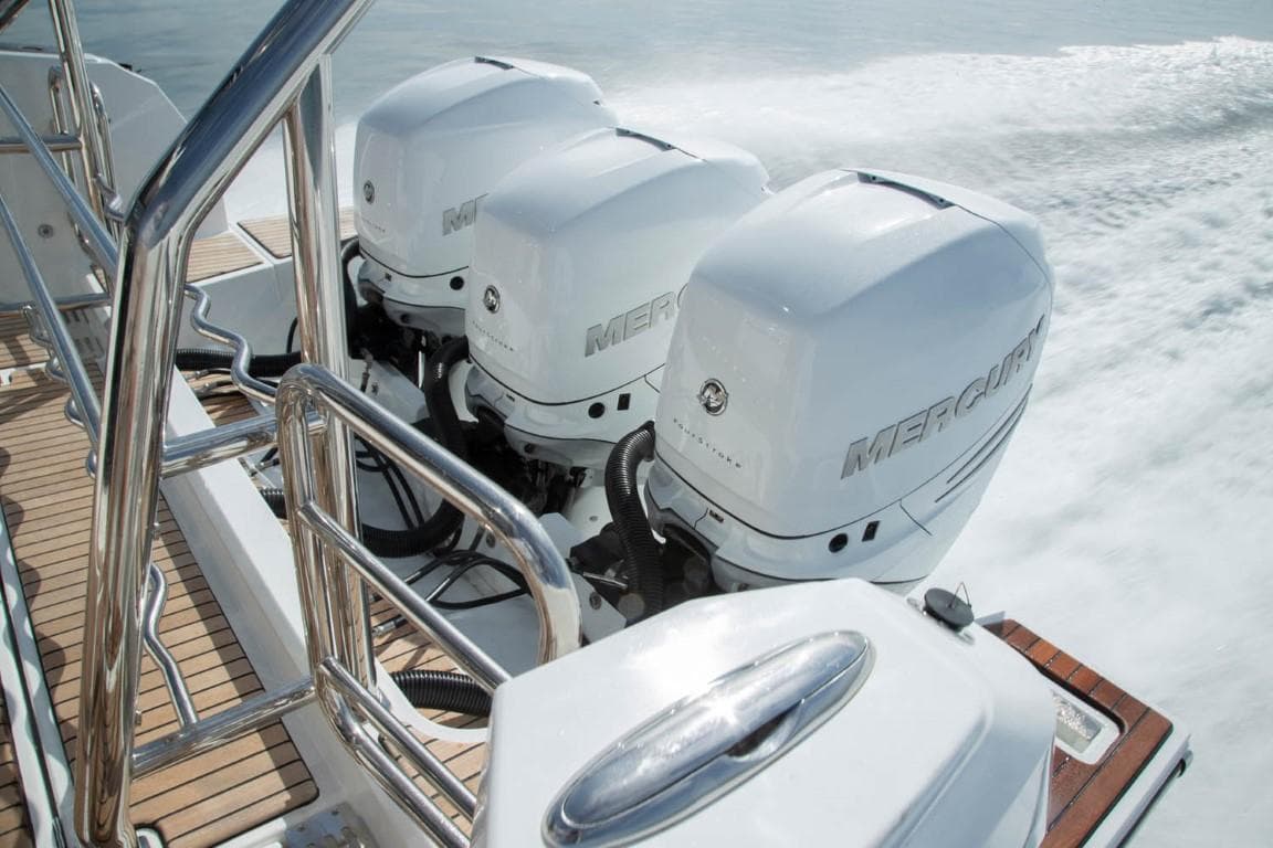 2025 Wellcraft 38 Explorer with triple Mercury outboard engines on the water.