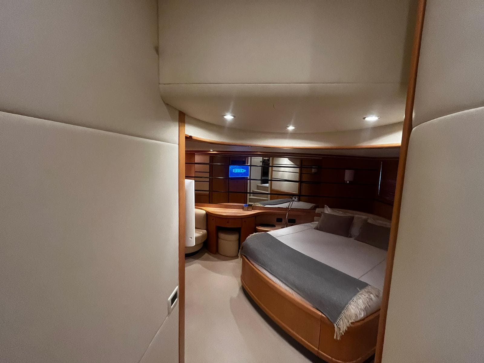 Luxurious bedroom interior of a 2004 Pershing 76 yacht with modern furnishings.