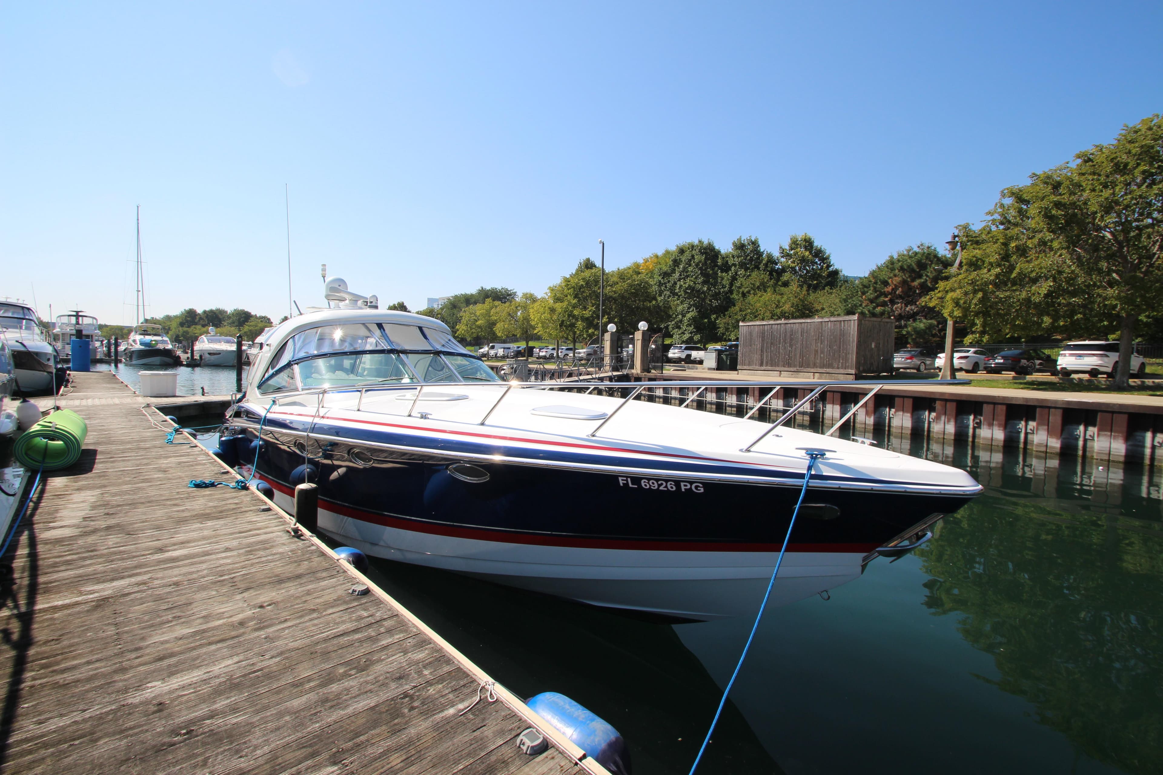 2012 Formula 400 Super Sport boat docked at a marina on a sunny day.