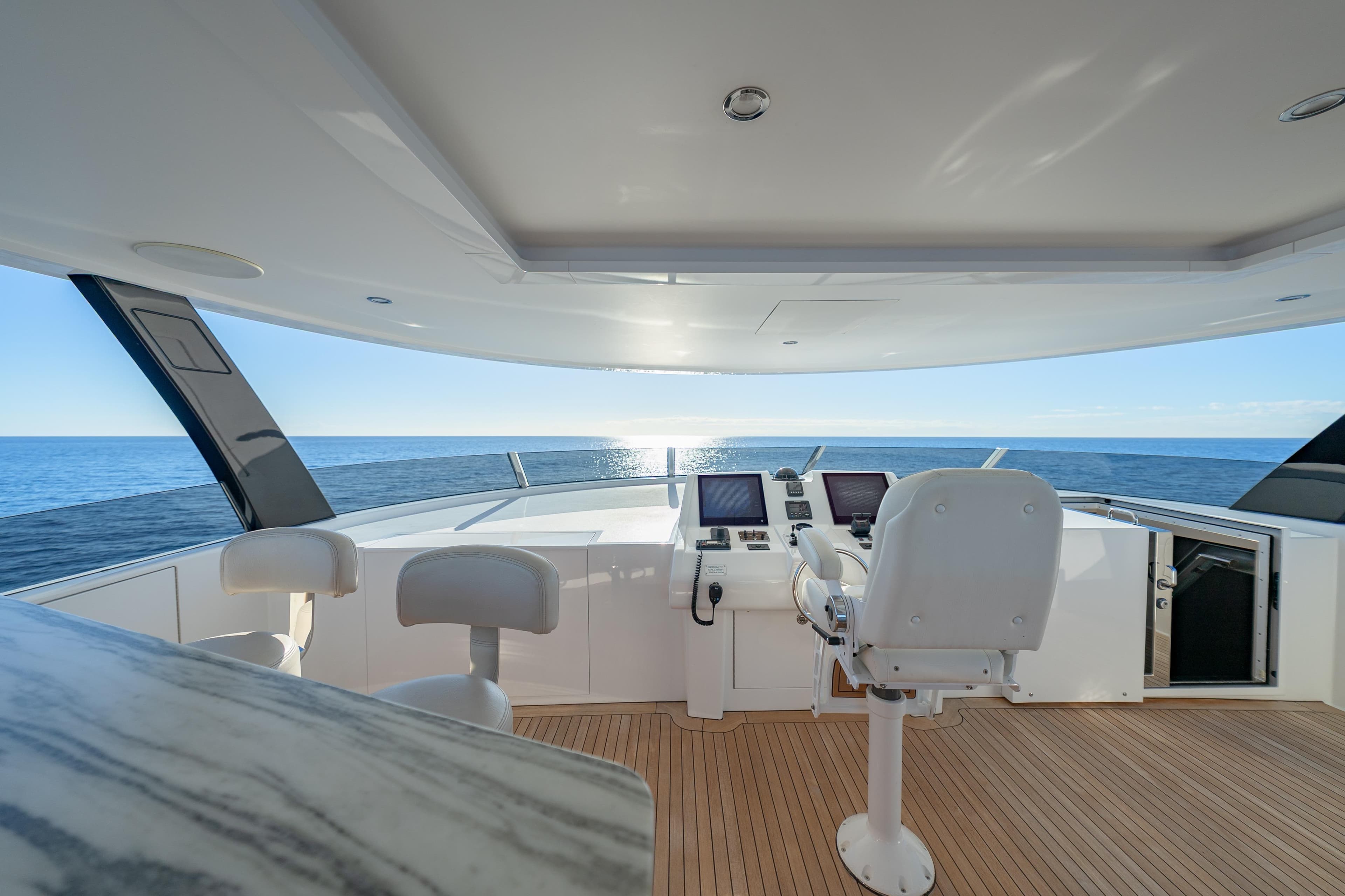 Luxurious 2018 Westport Raised Pilothouse yacht interior with ocean view and modern controls.