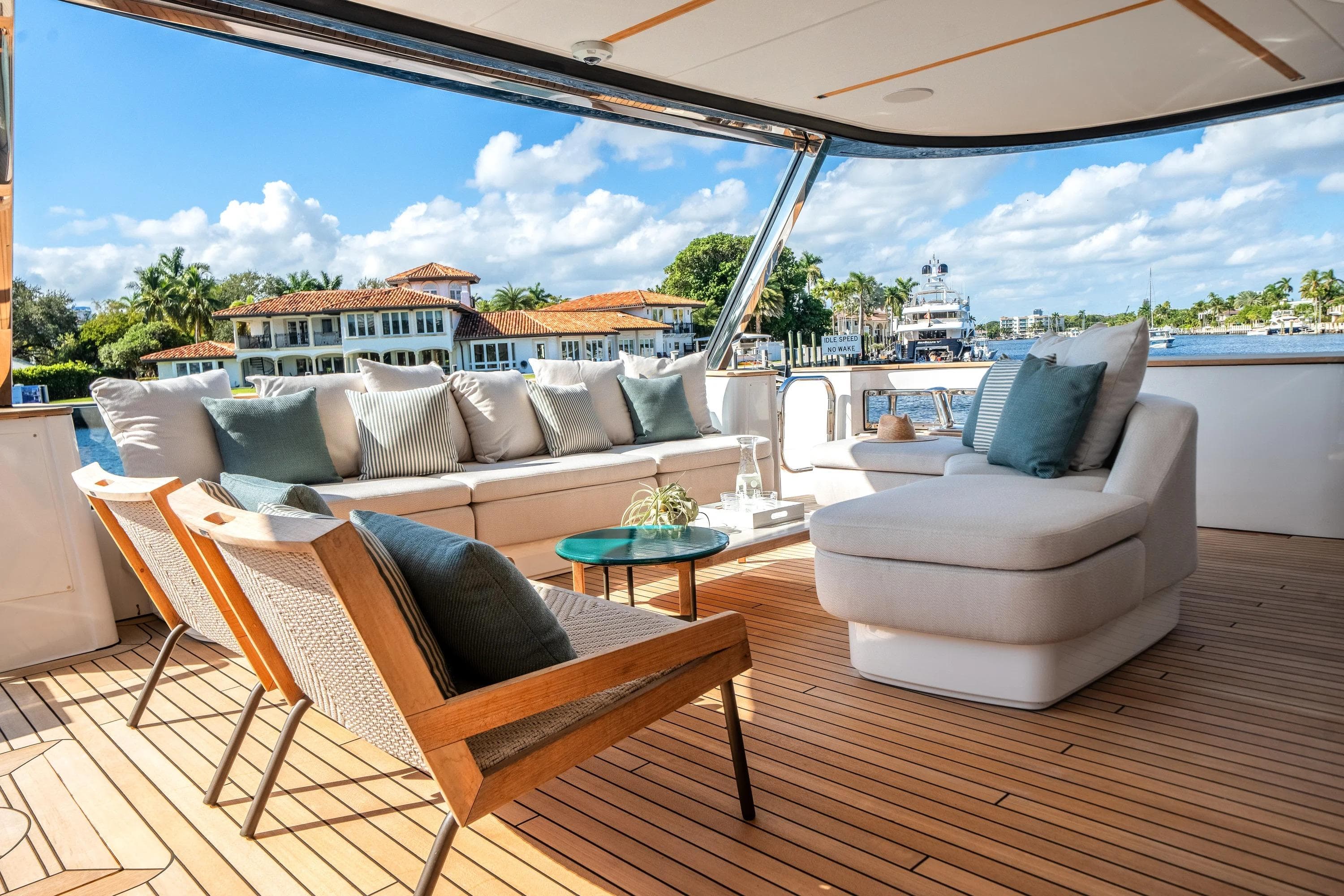 Luxurious deck of 2026 Azimut Magellano 30M yacht with elegant seating and scenic waterfront view.