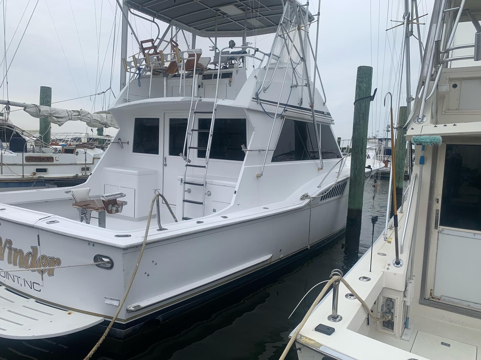 1974 Hatteras 46 Convertible yacht docked at marina.