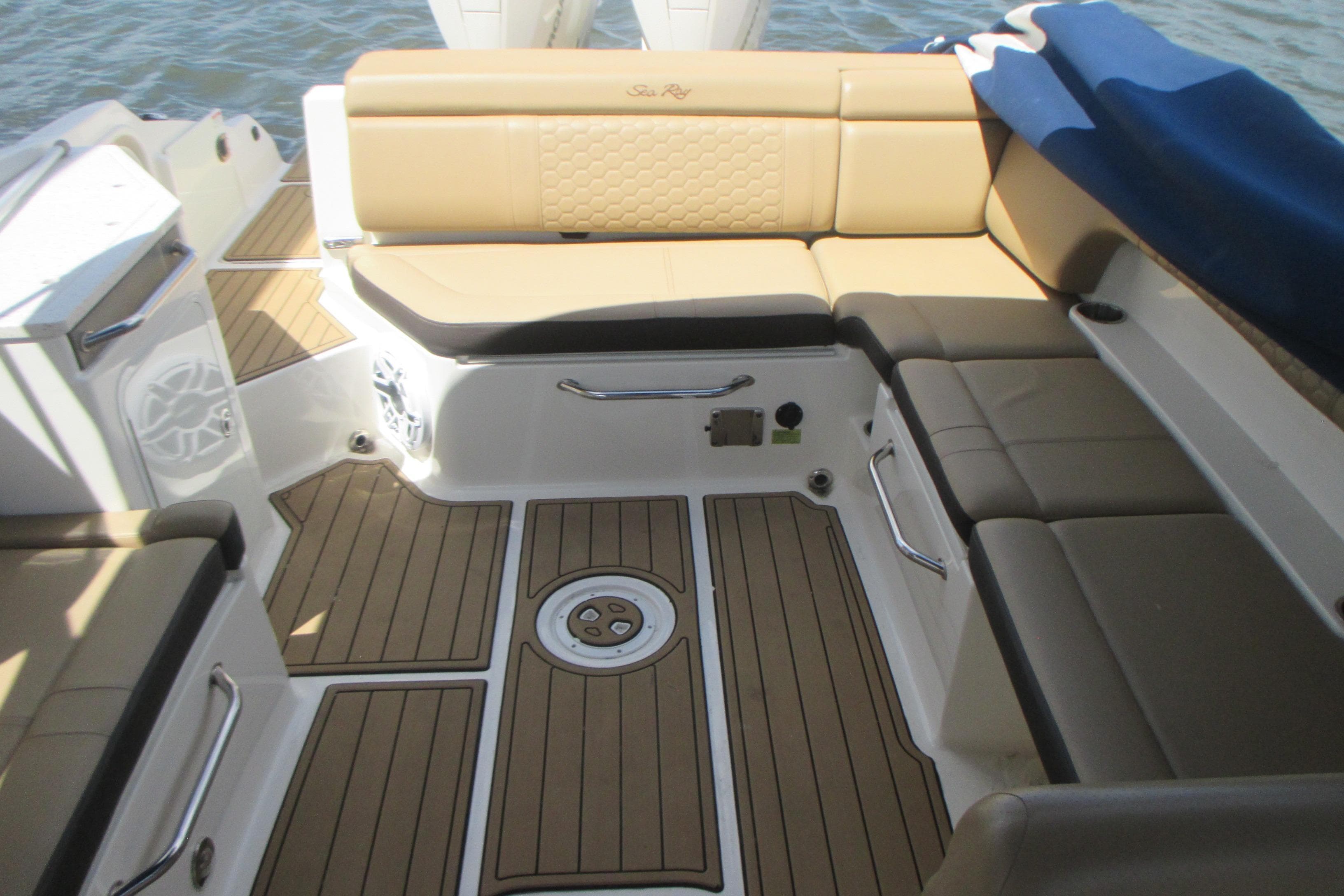 Luxurious interior of 2019 Sea Ray 290 SLX boat with tan seating and teak flooring.