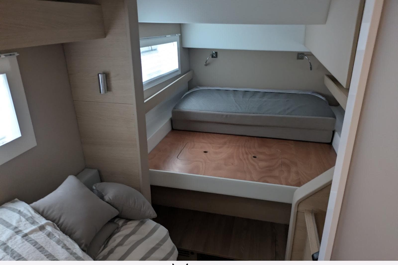 Interior of 2024 Aventura 37 yacht cabin with cozy beds and modern design.