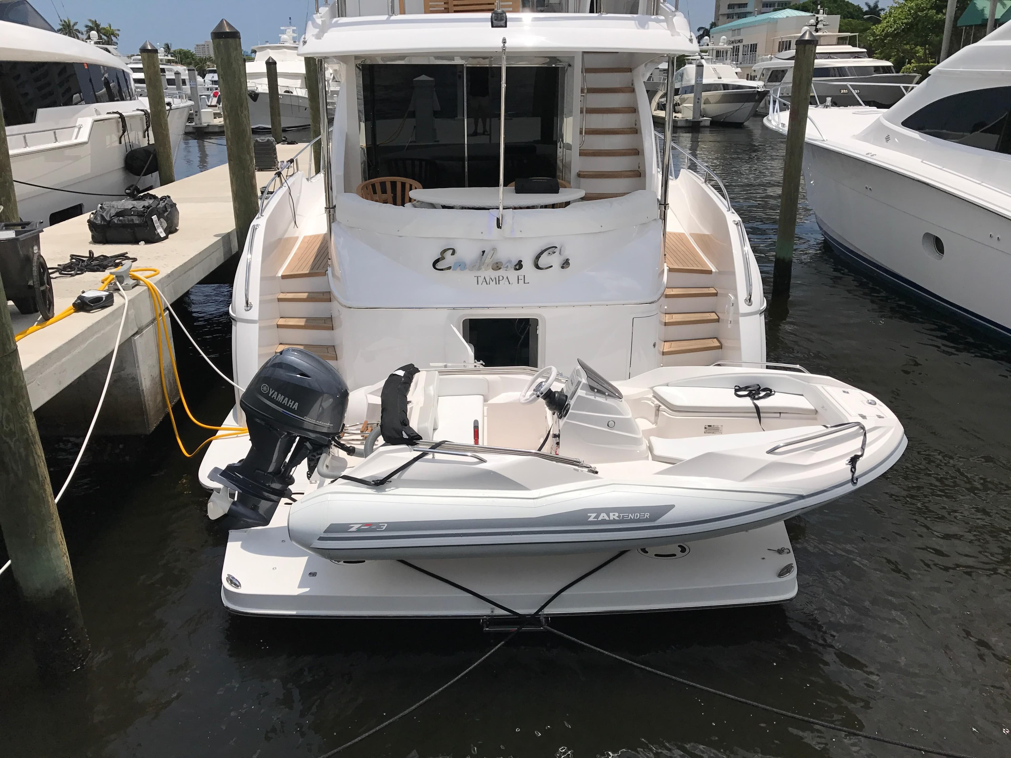 A 2025 Zar Formenti ZF-3 boat docked at a marina, featuring a sleek design.