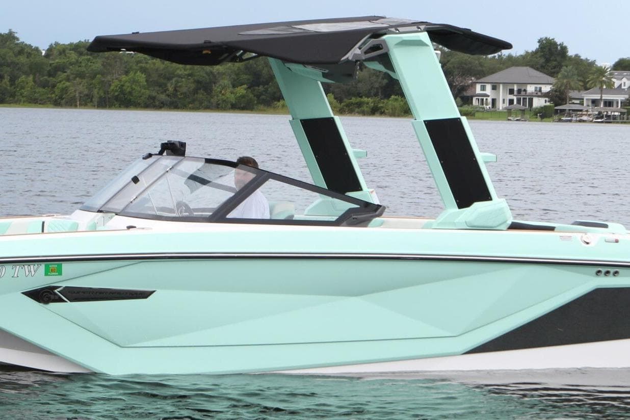 2024 Nautique Super Air Nautique G23 boat on a lake, featuring sleek design and modern features.