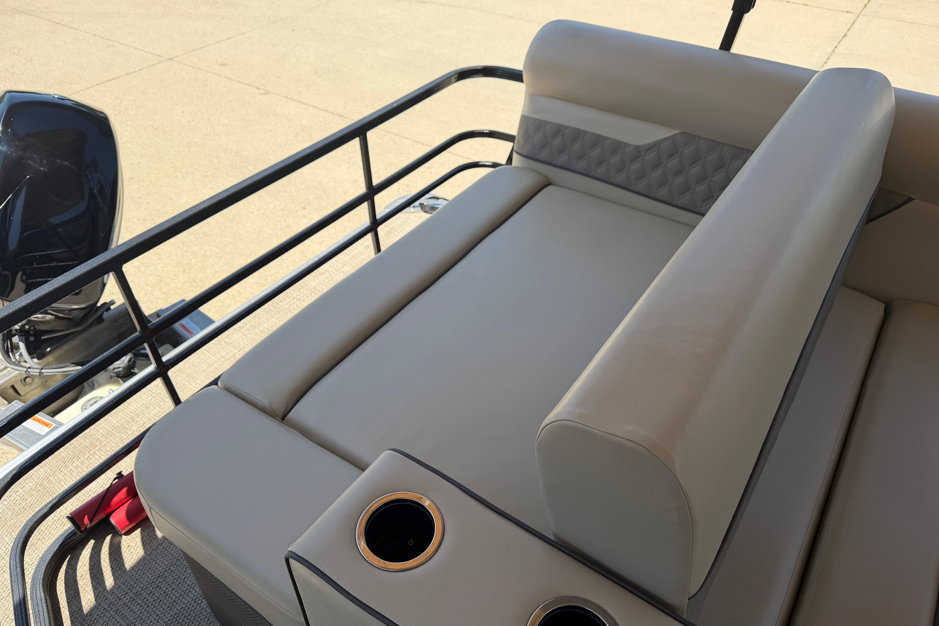 2022 Crest Classic DLX SLS 220 boat interior with beige seating and cup holders.
