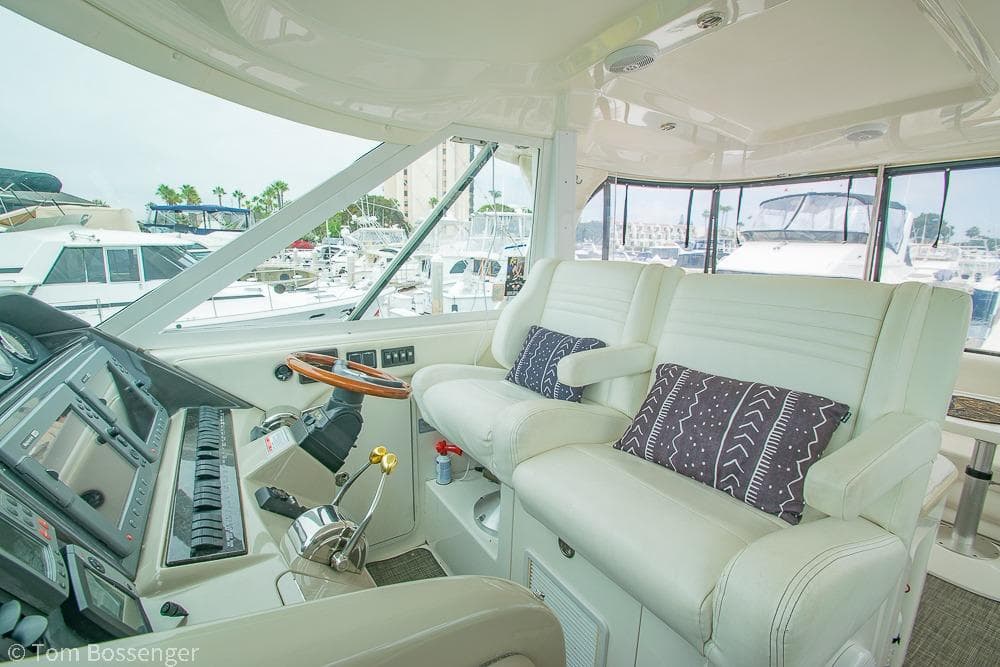 Interior of 2005 Sea Ray 390 Motor Yacht with plush seating and modern controls.