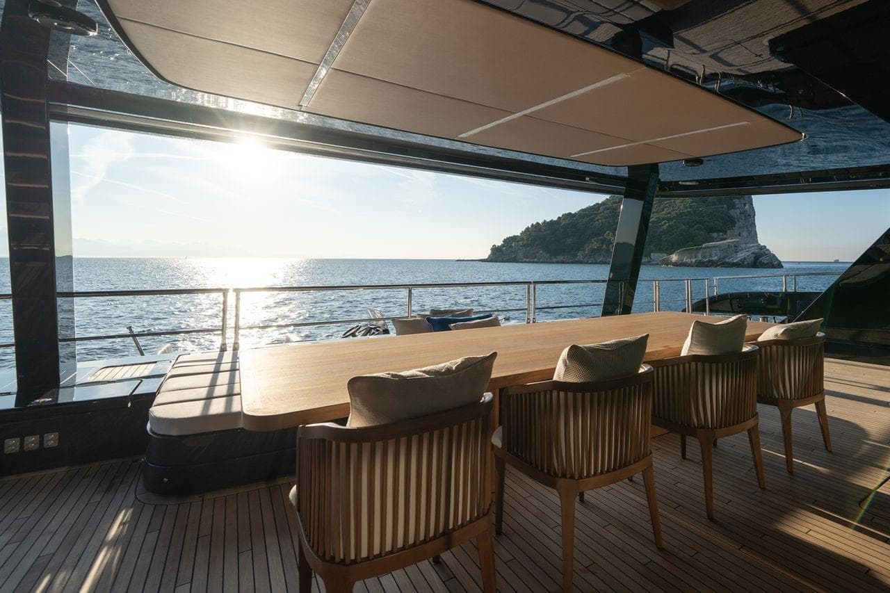 Luxurious Sunreef 100 Power yacht dining area with ocean view, 2025 model.