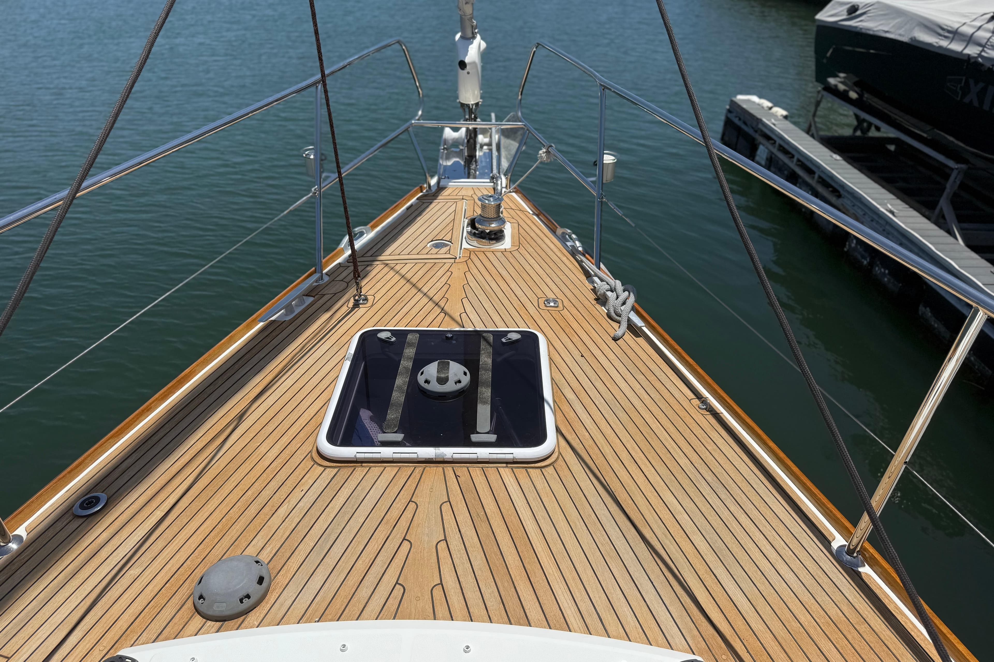 Deck view of 2018 Jeanneau 58 yacht with teak finish and hatch.