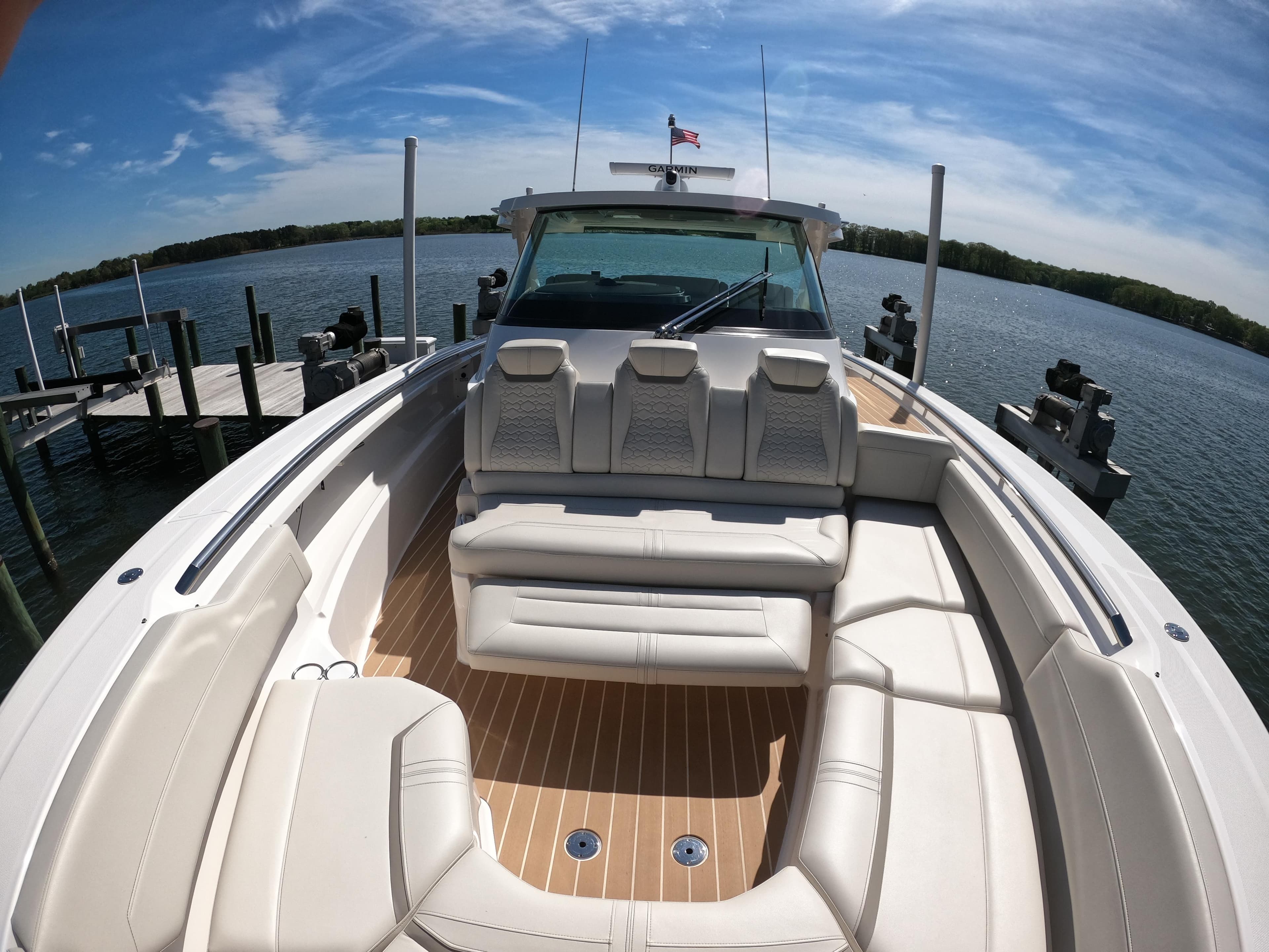 2024 Tiara Yachts 43 LS luxury boat with spacious seating on a sunny day.