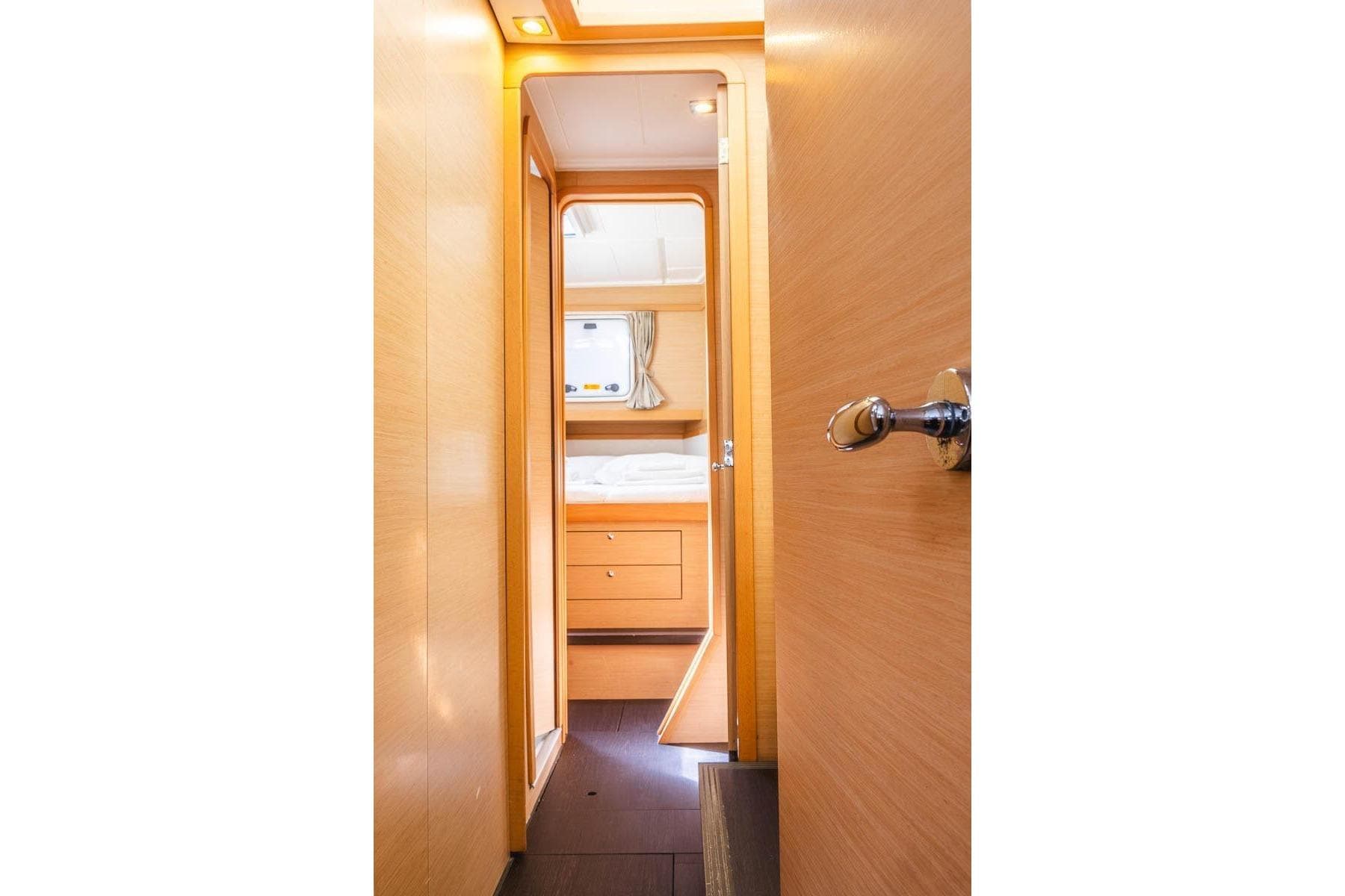 Interior view of 2016 Lagoon 39 yacht cabin with wooden finish and cozy bed.