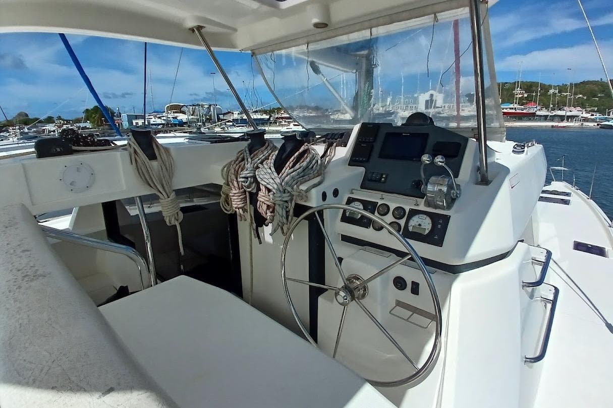 2018 Leopard 45 yacht cockpit with steering wheel and marina view.