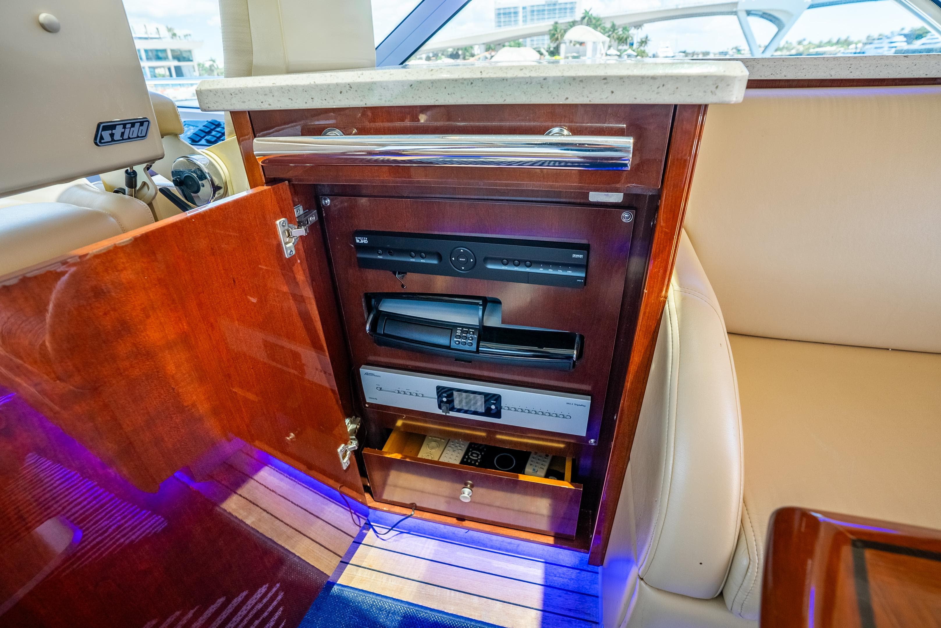 2008 Sea Ray 60 Sundancer interior with open cabinet revealing electronic equipment.