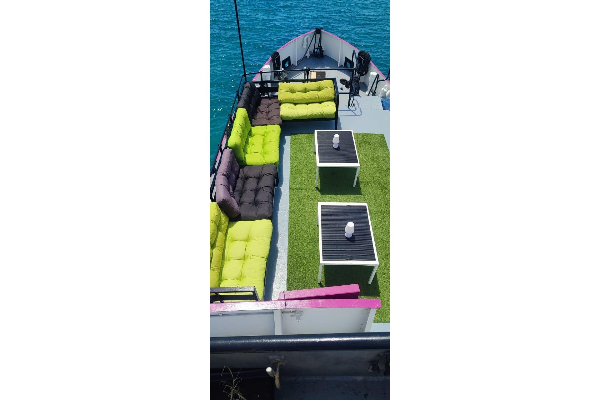 Custom 1970 CD Holmes Clovelly Class Tender Fleet with vibrant seating and tables on deck.