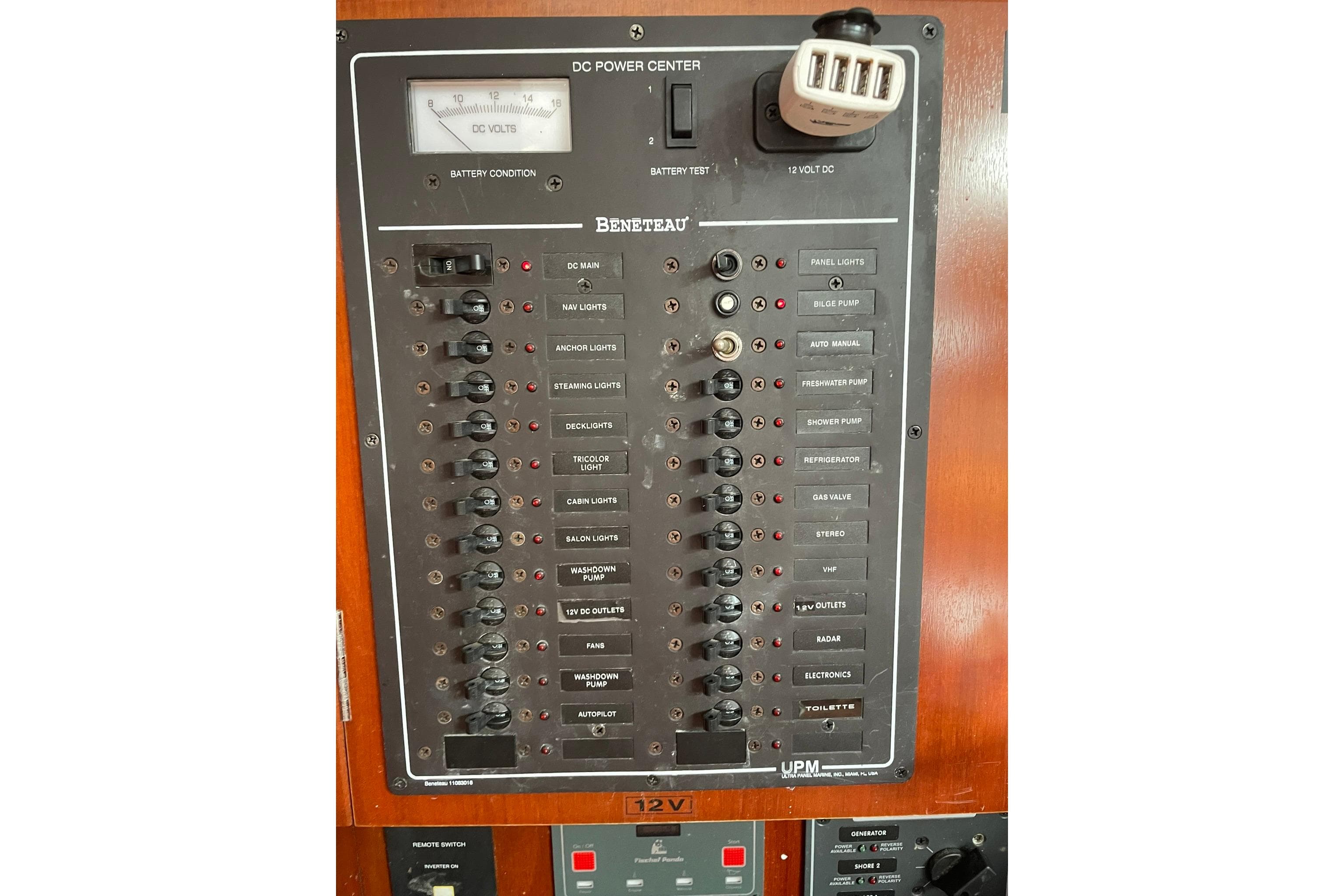 Electrical panel of a 2003 Beneteau 423 sailboat, featuring various switches and controls.