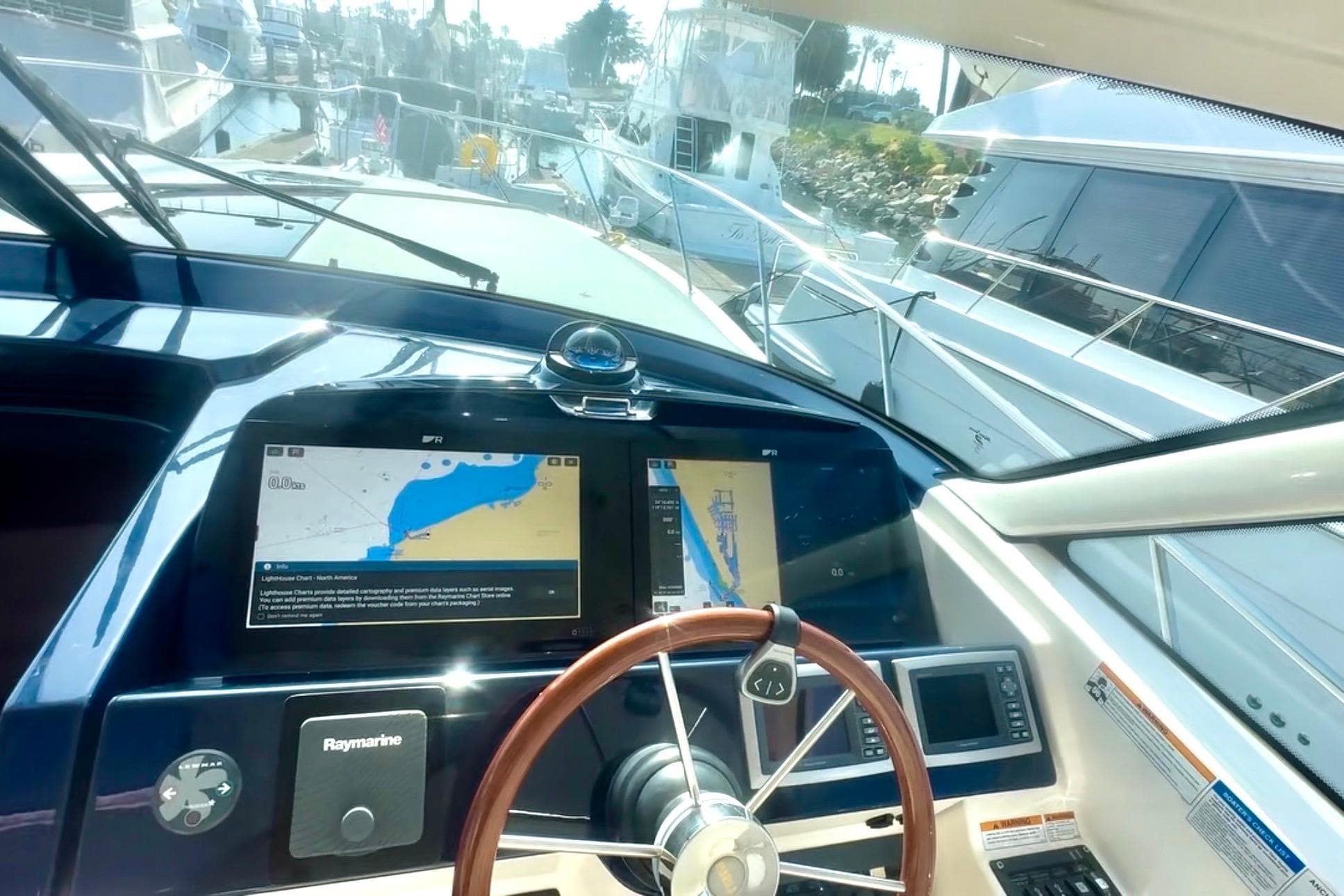 Helm of 2011 Tiara Yachts 4300 Open with navigation screens and steering wheel.