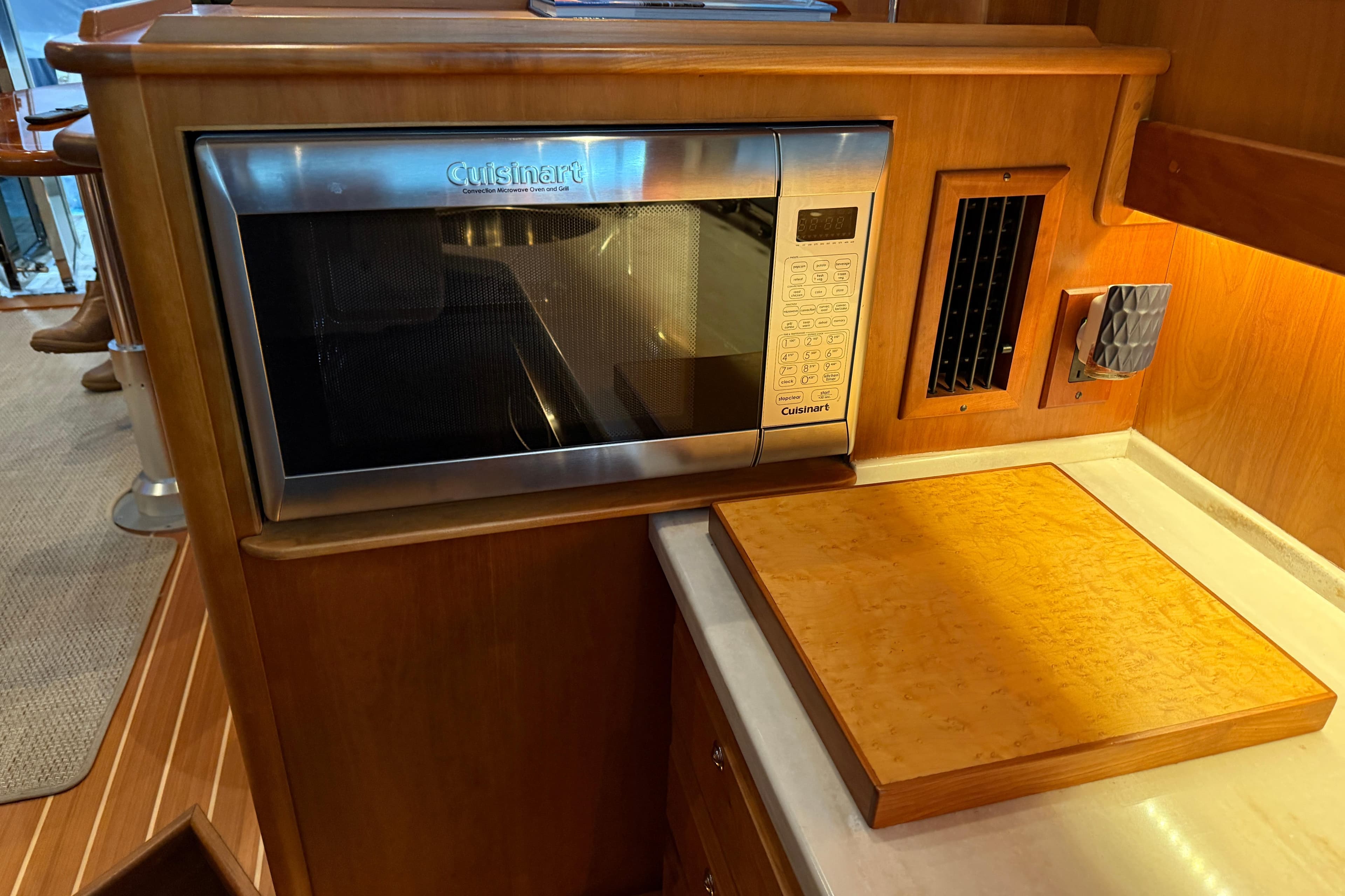 2021 Sabre 42 Fly Bridge kitchen with Cuisinart microwave and wooden countertop.