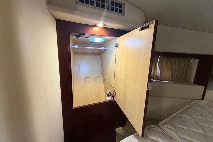 Interior cabin of 2008 Sea Ray 36 Sedan Bridge with open wooden cabinet.