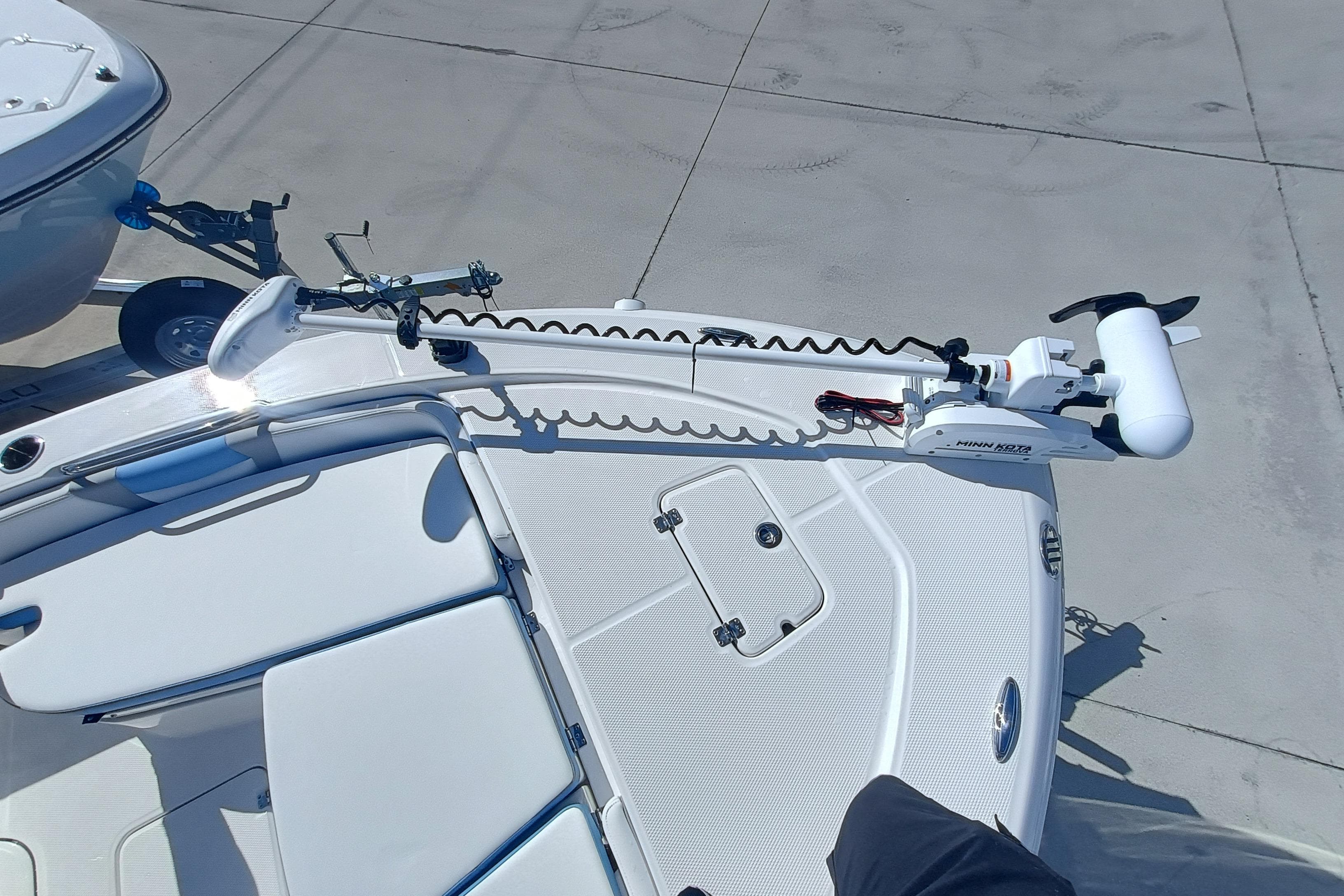 2026 Robalo 226 Cayman boat with Minn Kota trolling motor on deck.