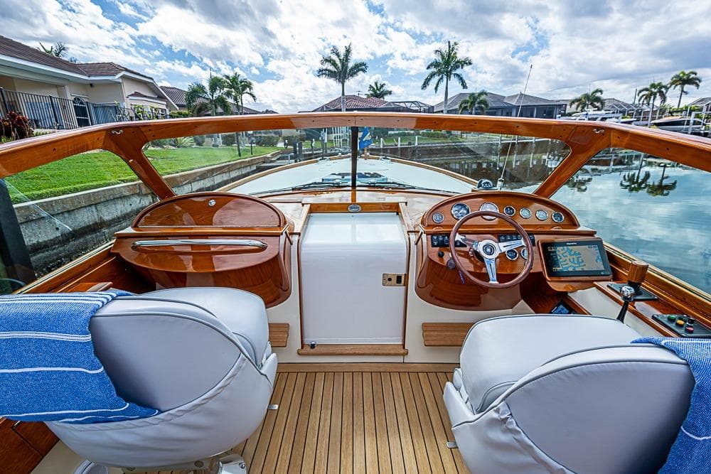 2004 Hinckley Talaria 29 R boat interior with wooden dashboard and leather seats.