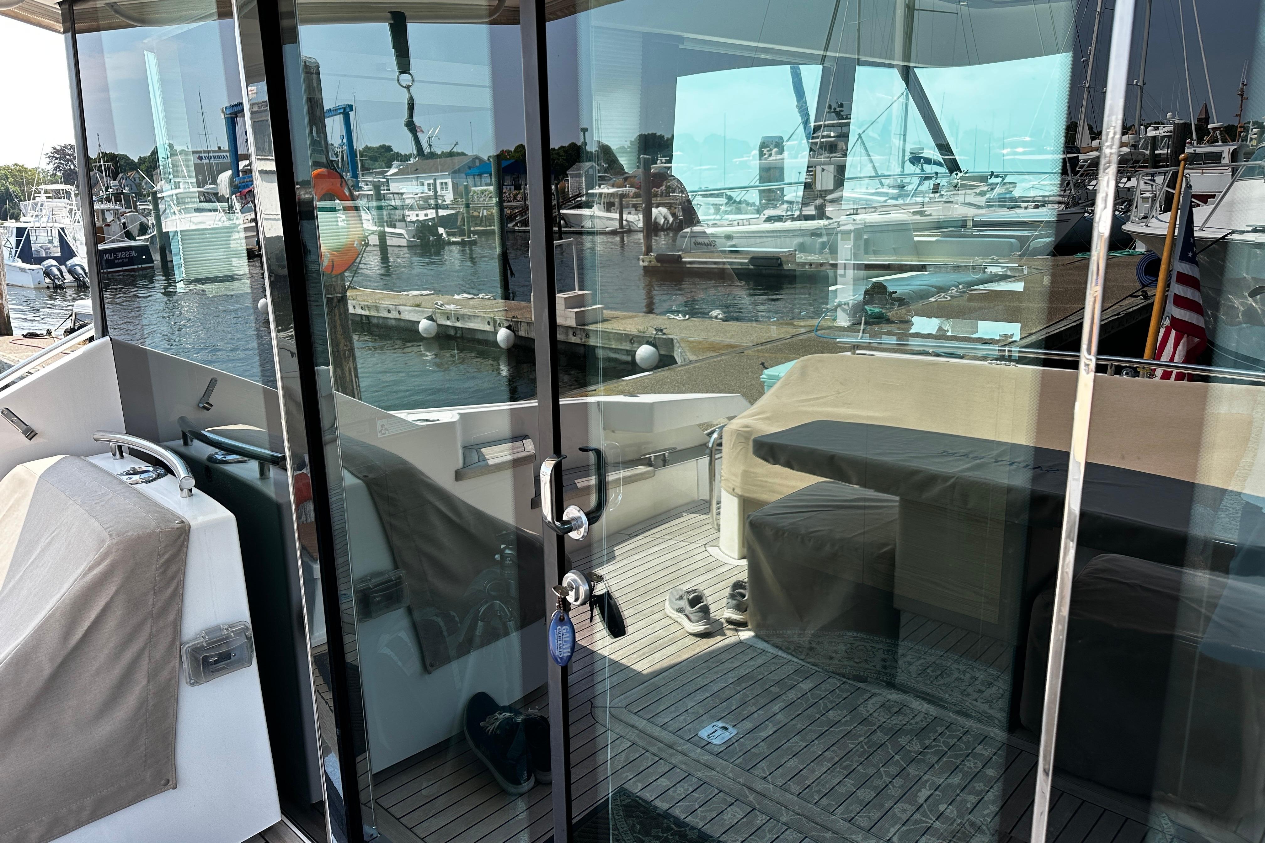 2014 Tiara 5000 Coupe yacht interior with marina view through glass doors.