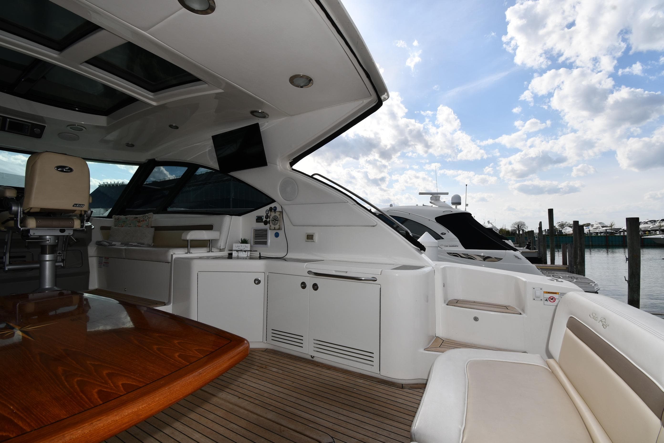 Luxurious 2013 Sea Ray Sundancer 540 yacht interior with elegant seating and wooden table.