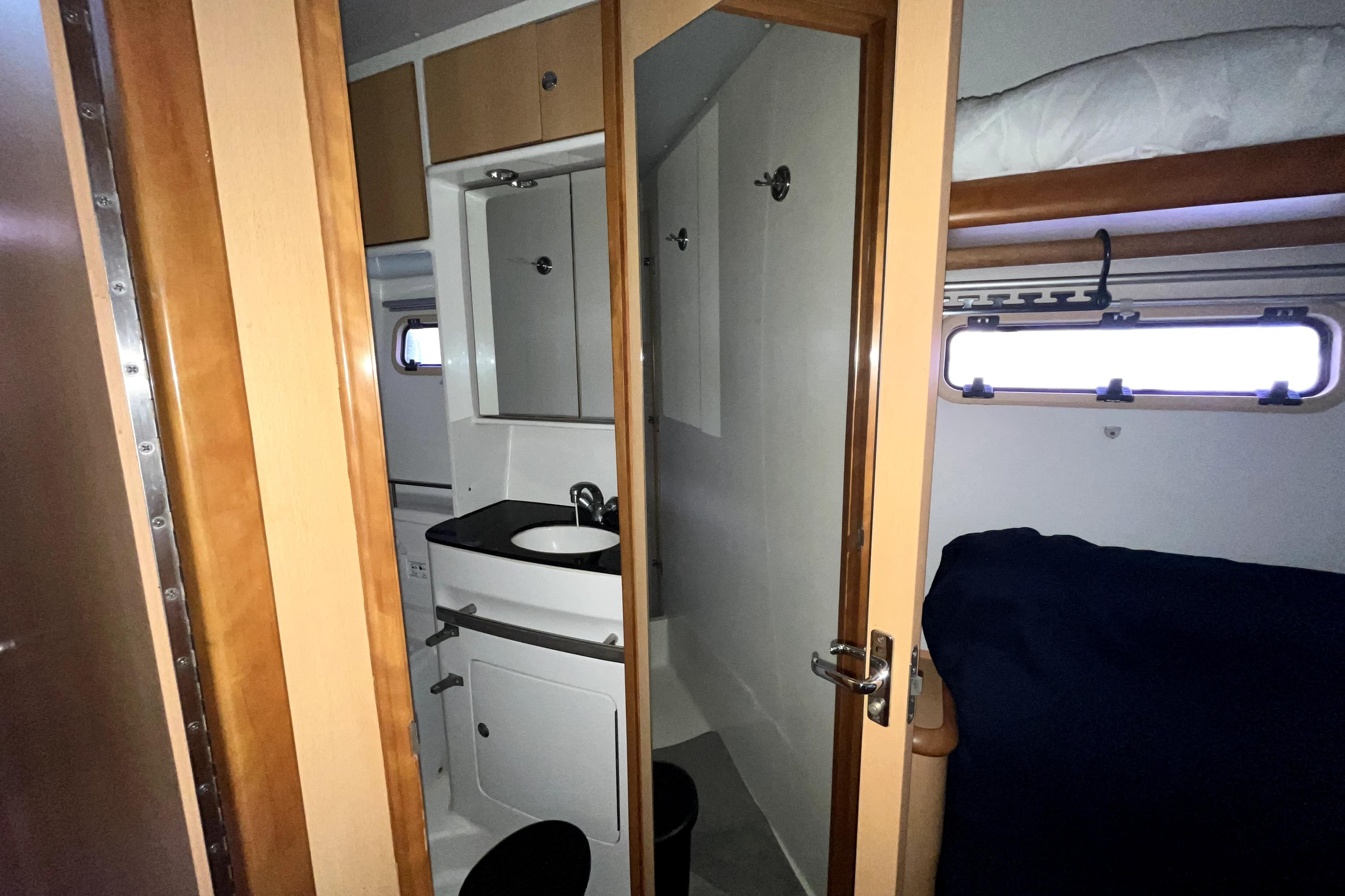Interior of 2009 Kelsall 58 KSS yacht cabin with bunk bed and compact bathroom.