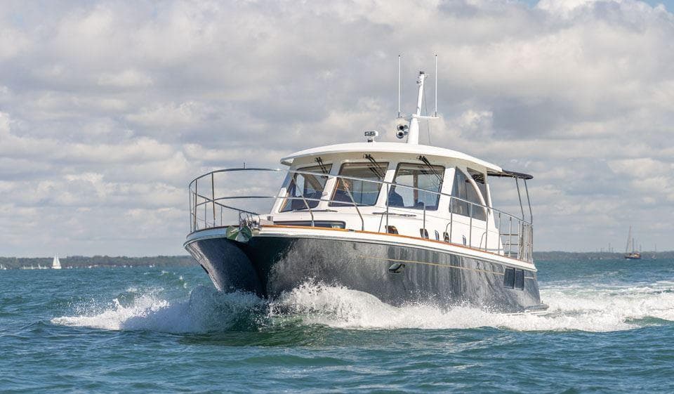2010 Hunt Yachts 52 cruising on open water under a cloudy sky.