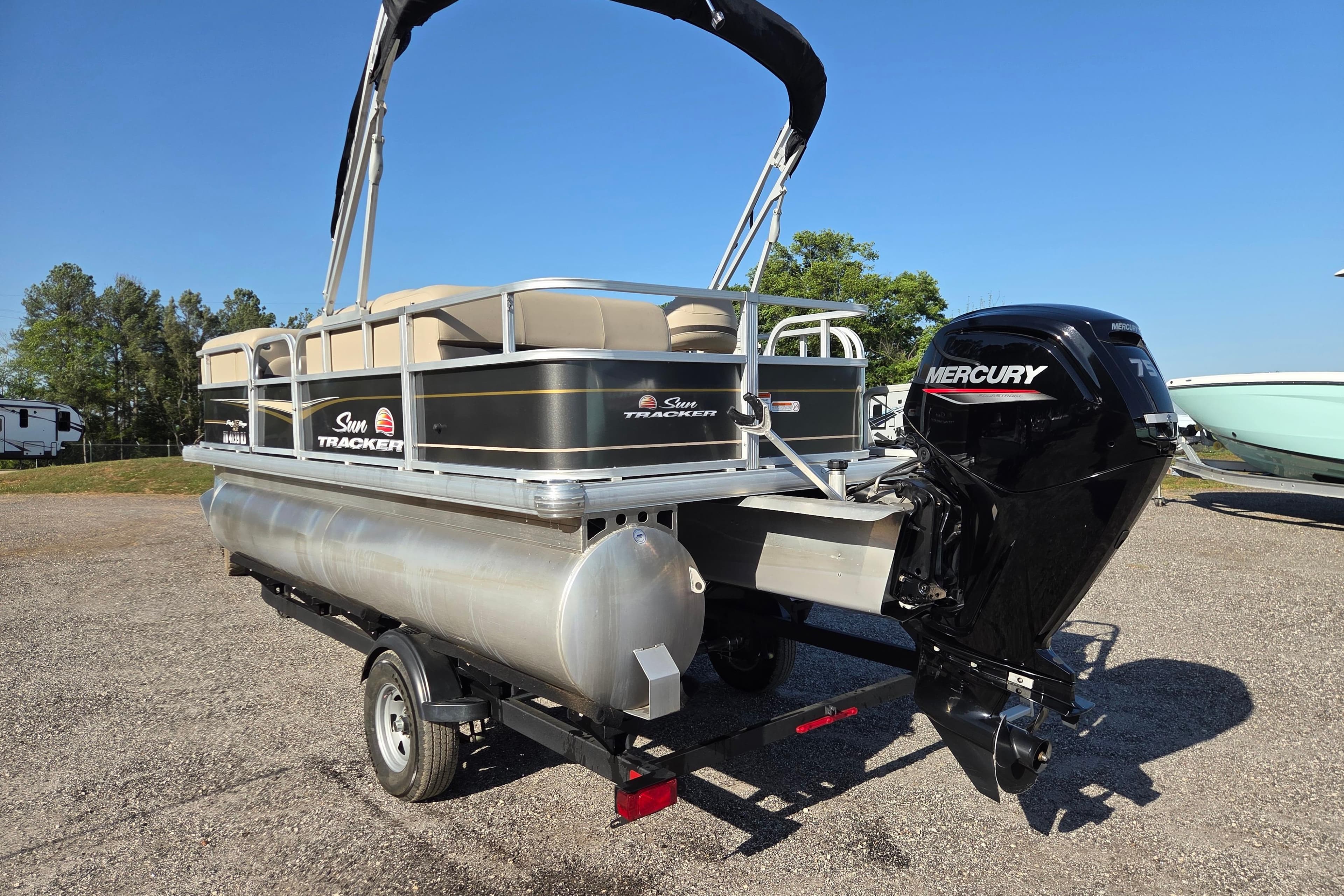 2022 Sun Tracker Party Barge 18 DLX pontoon boat with Mercury engine on trailer.