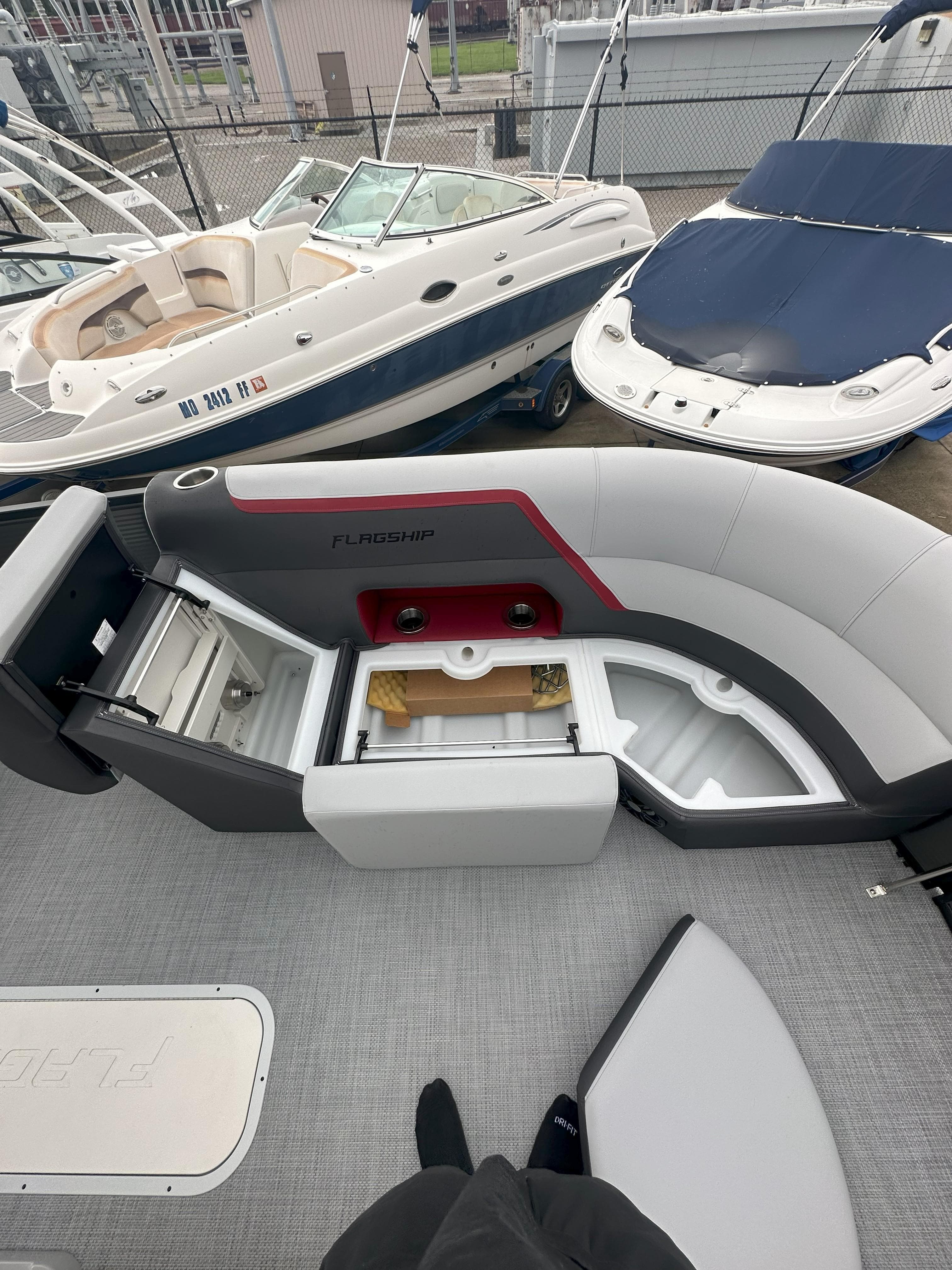 2026 Flagship D22CU Extended Deck boat with open storage compartments and seating.