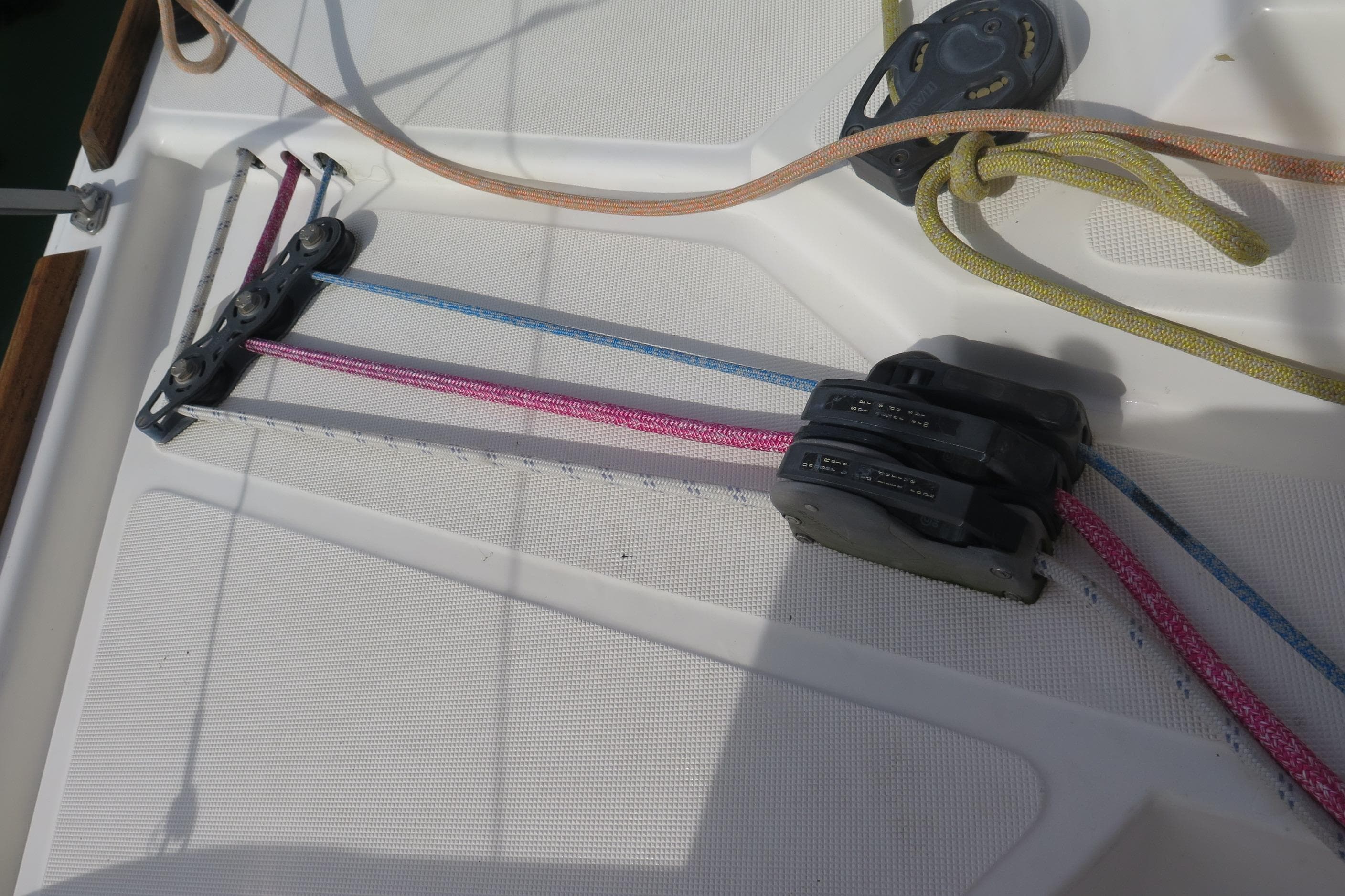 Deck rigging on 2011 Catana 47 sailboat with colorful ropes and pulleys.