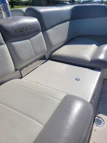 Interior of a 2008 MasterCraft MariStar 245 boat with gray leather seats.