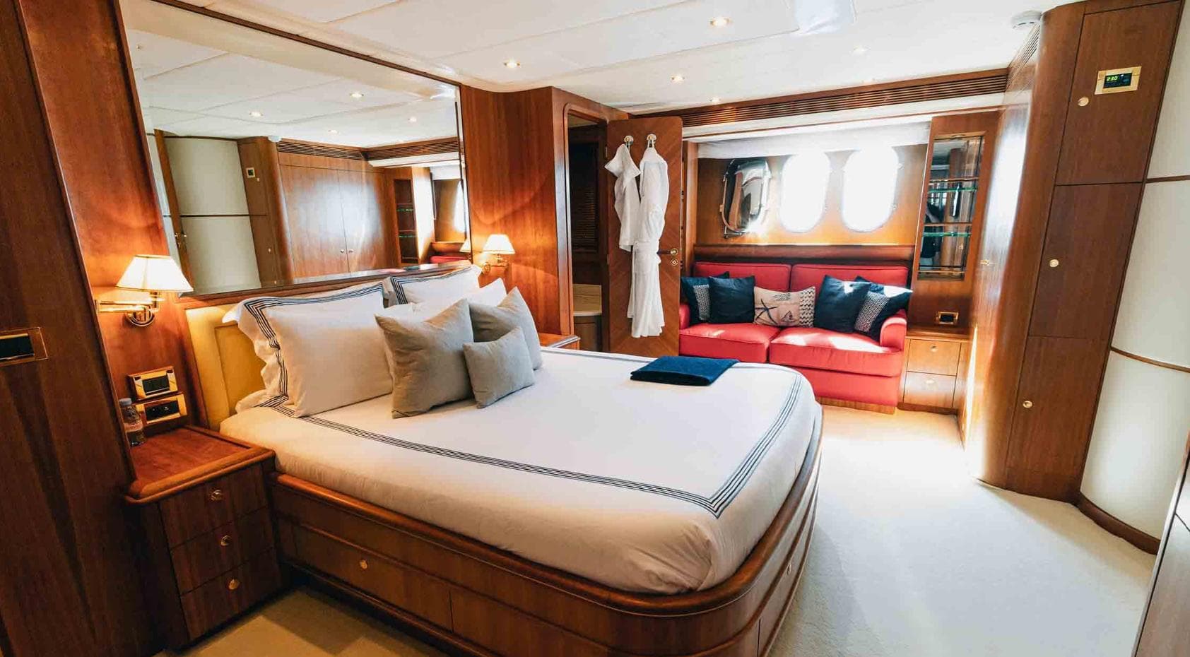 Luxurious bedroom interior of 2006 Couach 3000 Fly yacht with elegant wood finishes.