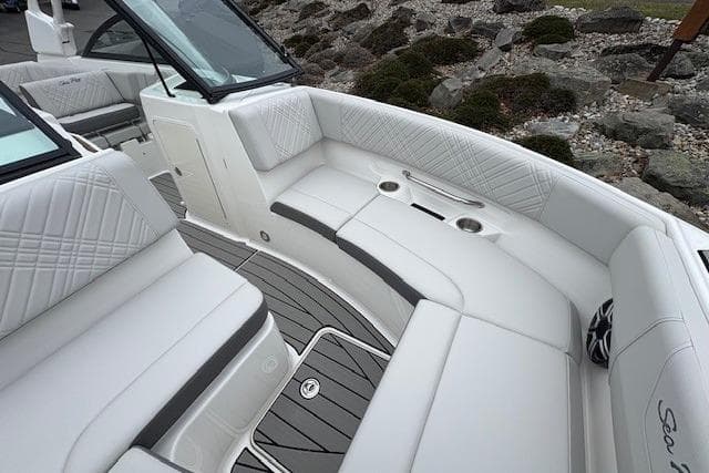2026 Searay SDX250 boat interior with white seating and cup holders.