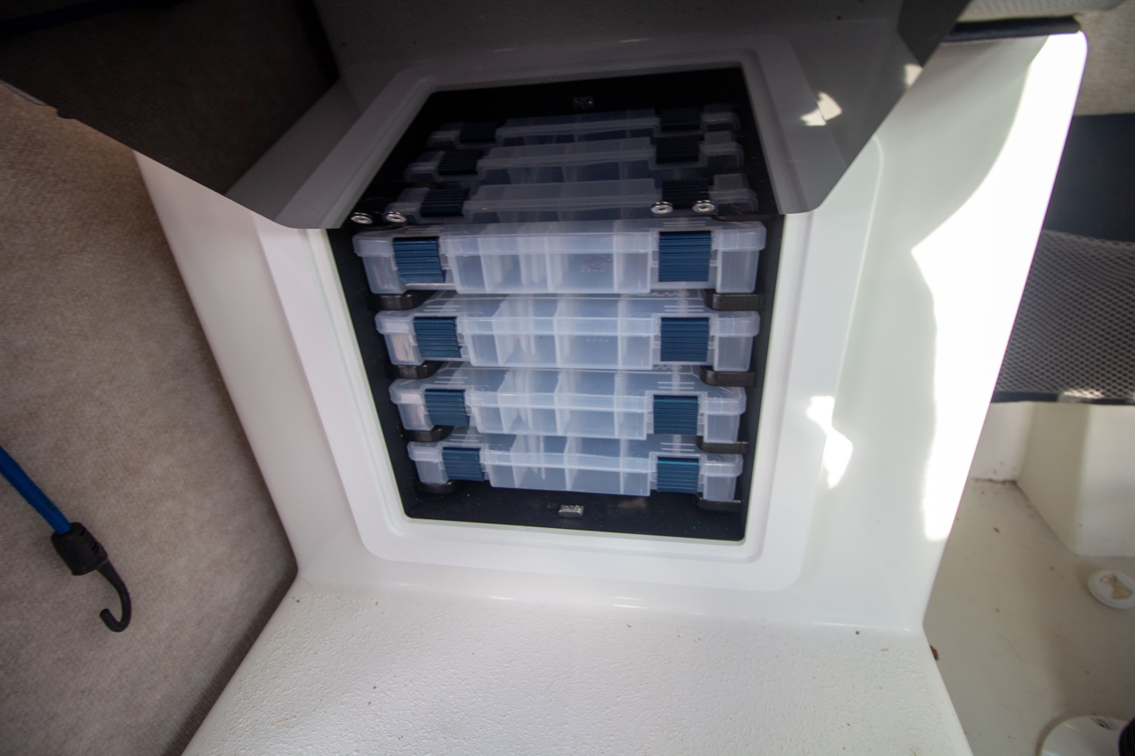 Storage compartment in Parker 2520 XLD Sport Cabin boat, 2022 model.