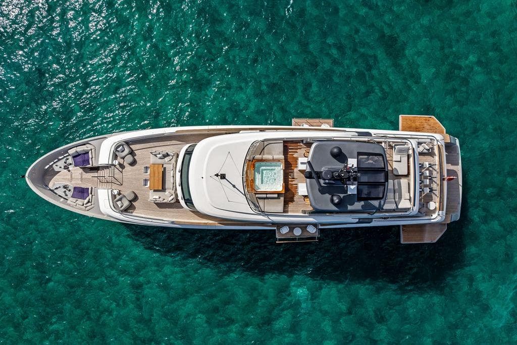 Aerial view of 2023 Sanlorenzo SD118 yacht on turquoise water.