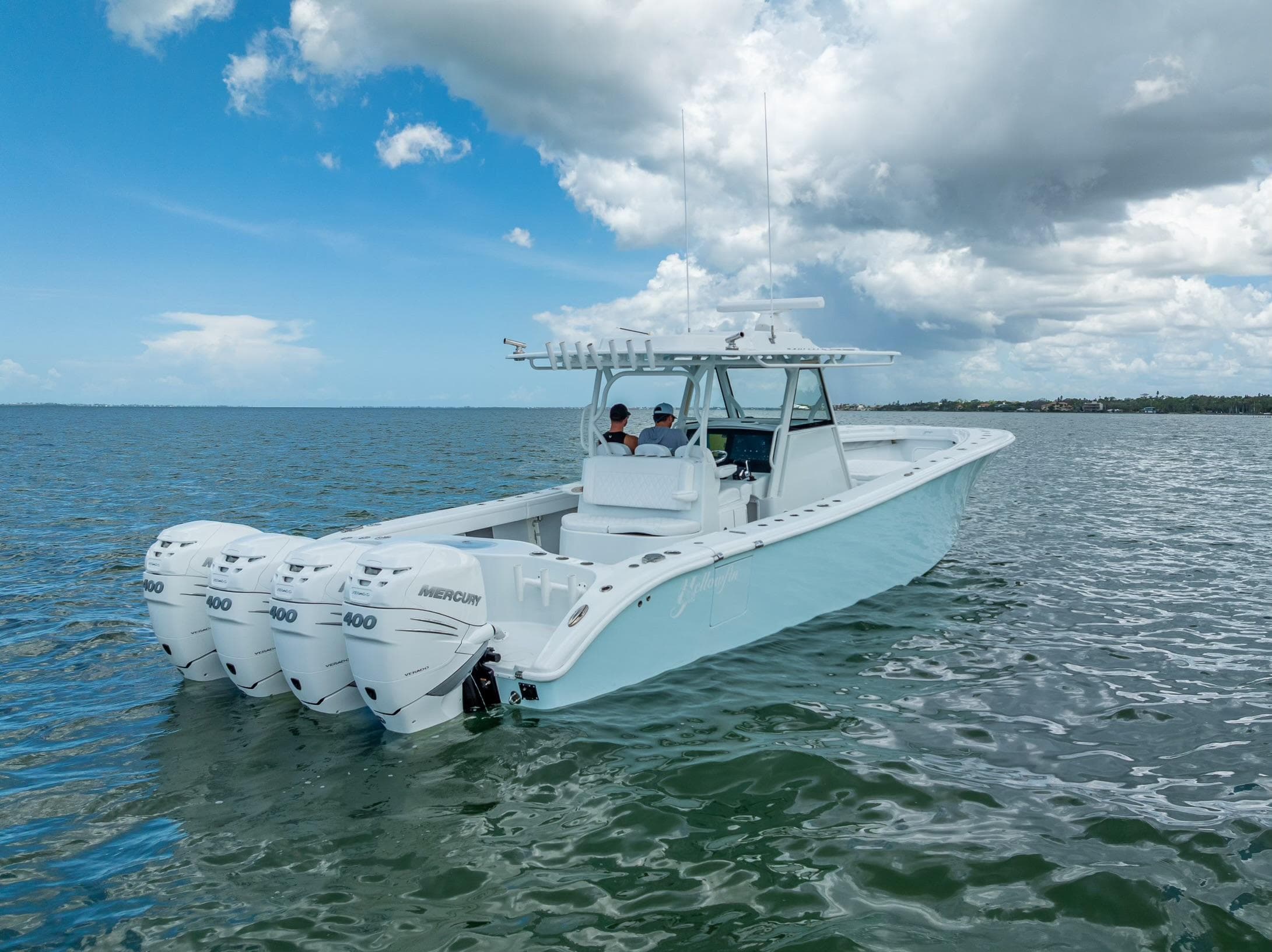 2023 Yellowfin 39 Offshore boat with four engines on open water under a cloudy sky.