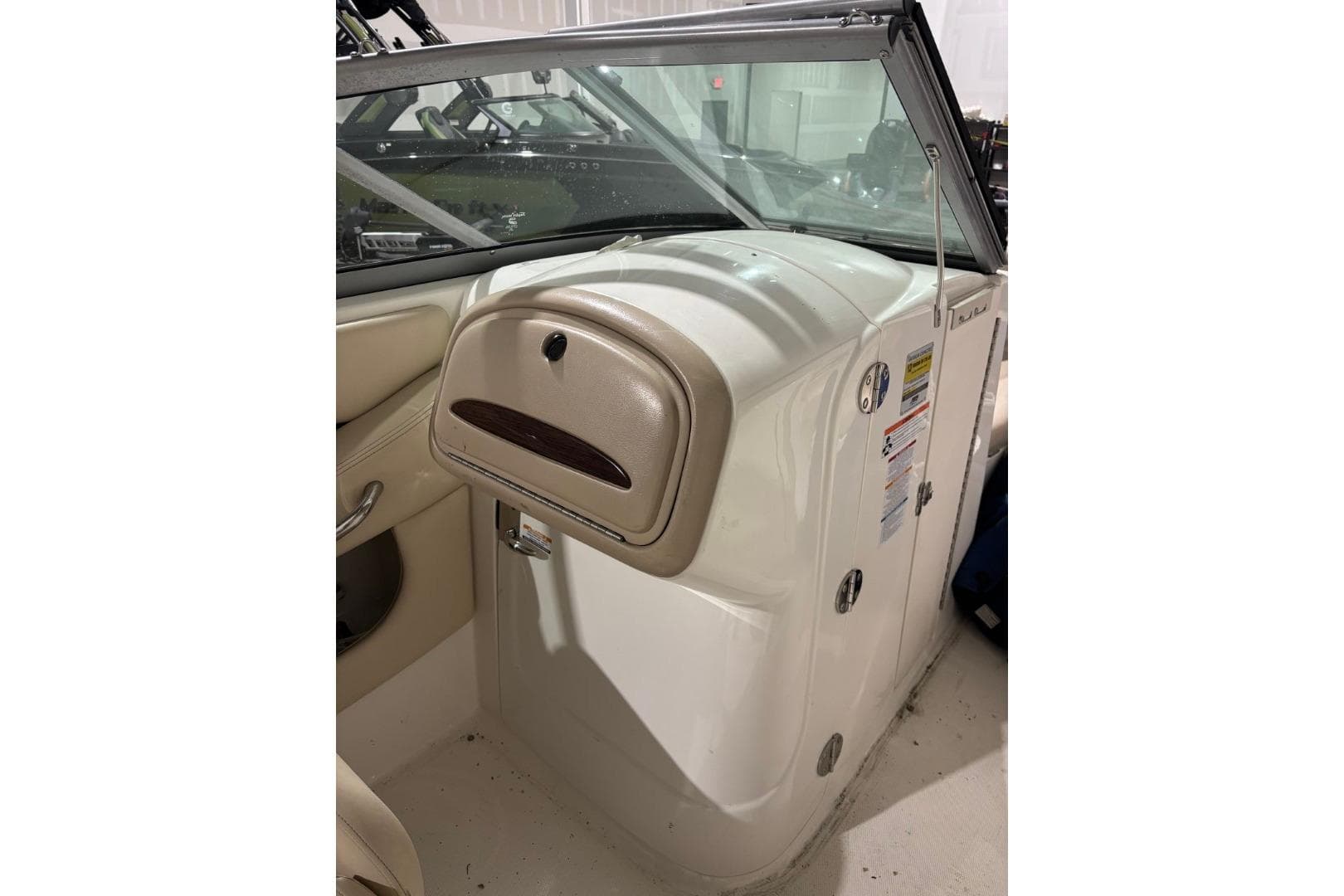 2008 Chaparral 246 SSi boat interior with beige dashboard and windshield.