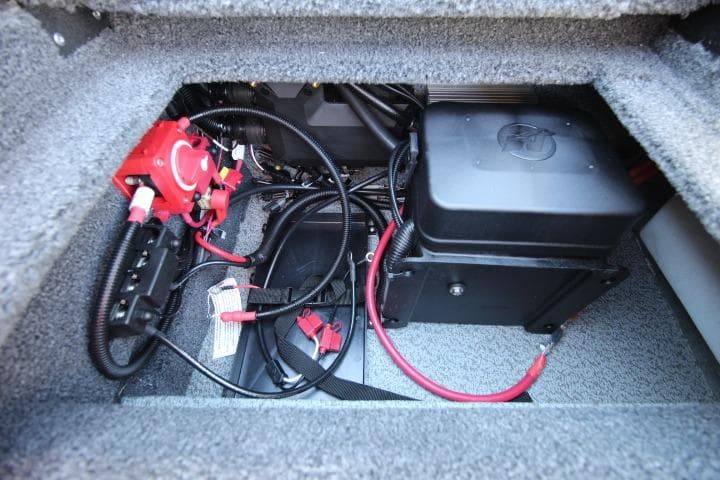 2026 Lund 2275 Baron boat battery compartment with wiring and connections.