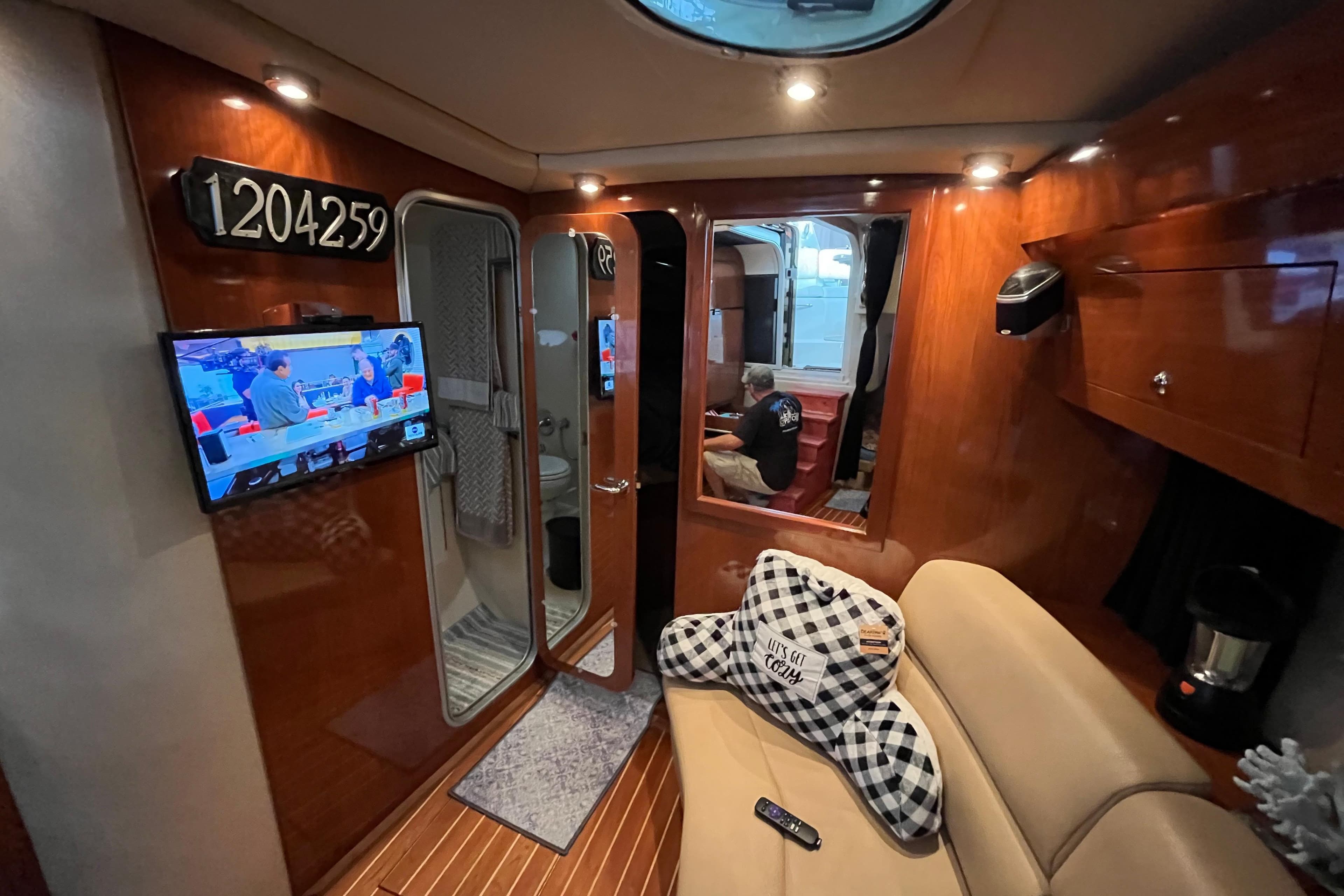 Interior of 2007 Regal 3760 IB Commodore yacht with TV, seating, and wood paneling.