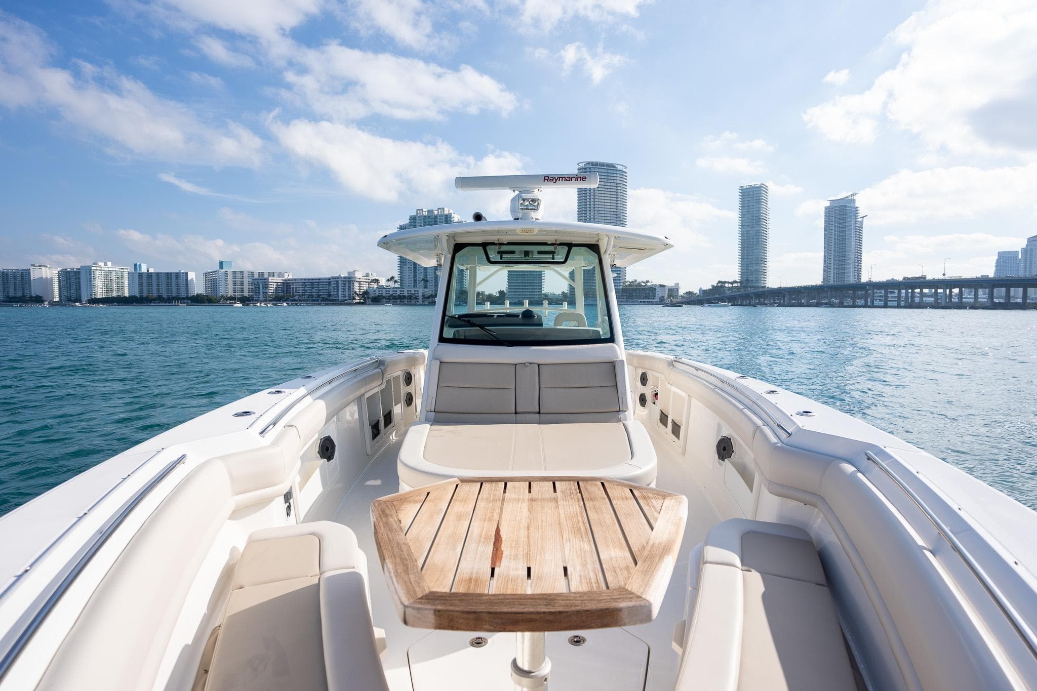 2020 Boston Whaler 380 Outrage boat on water with city skyline background.