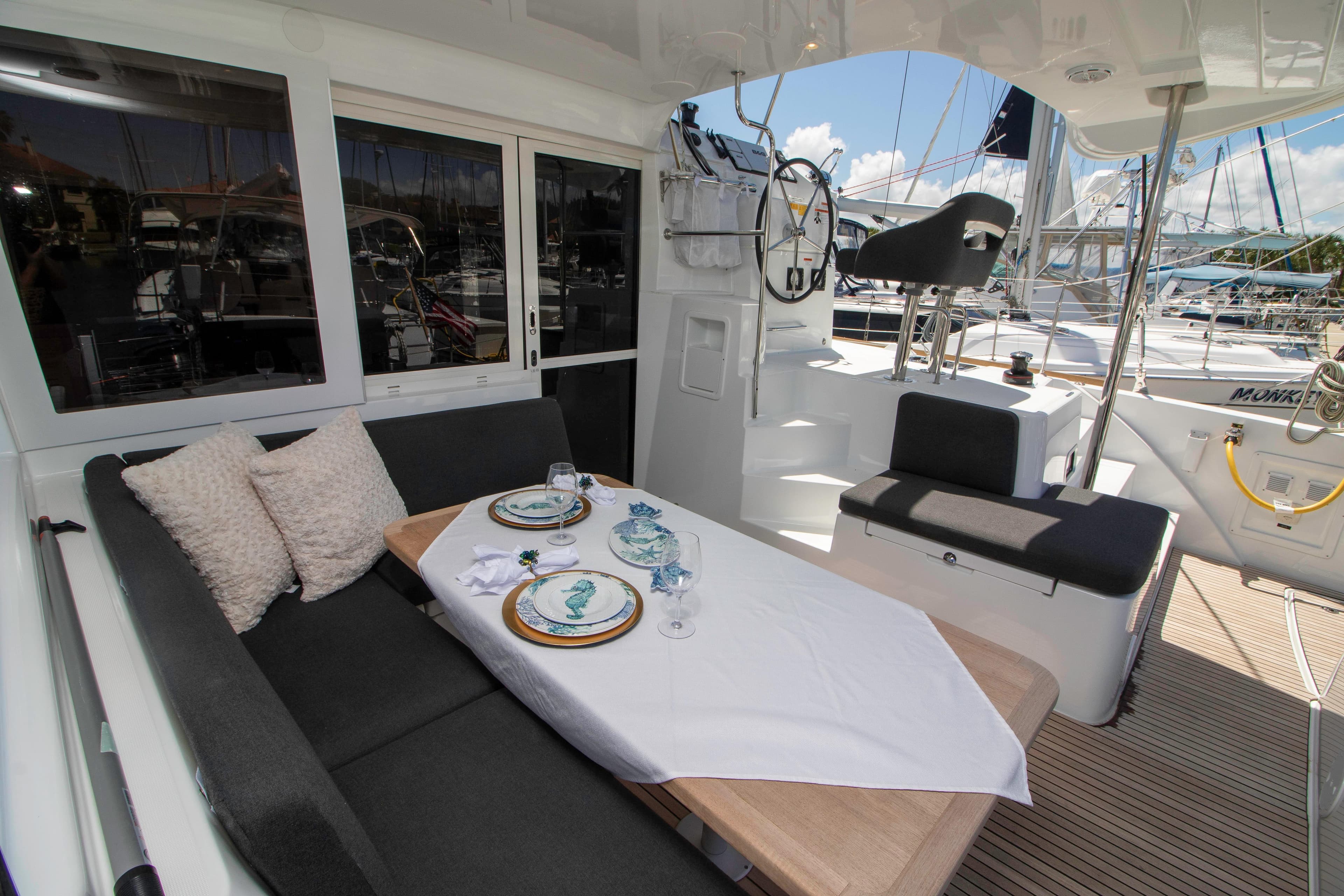 Luxurious Lagoon 40 catamaran cockpit with elegant dining setup, 2019 model.